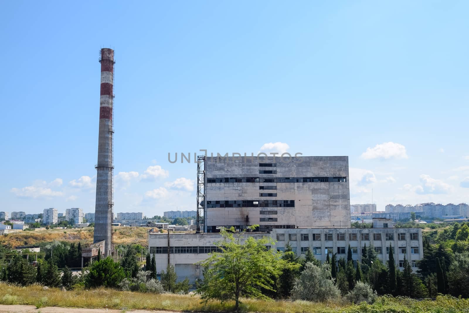 An old Soviet factory with a pipe. Abandoned Soviet industry.