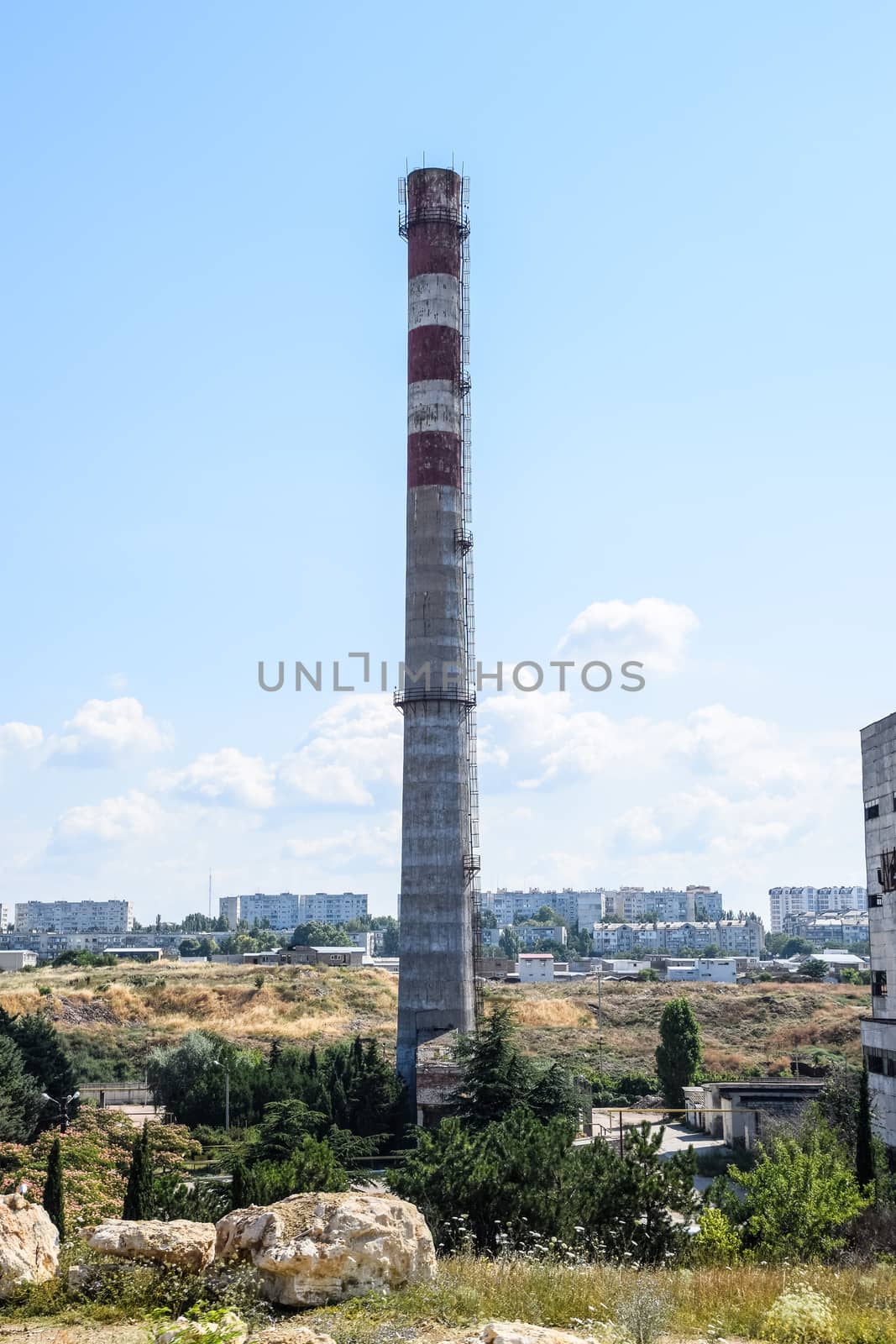 old Soviet factory with a pipe. Abandoned Soviet industry. by fedoseevaolga