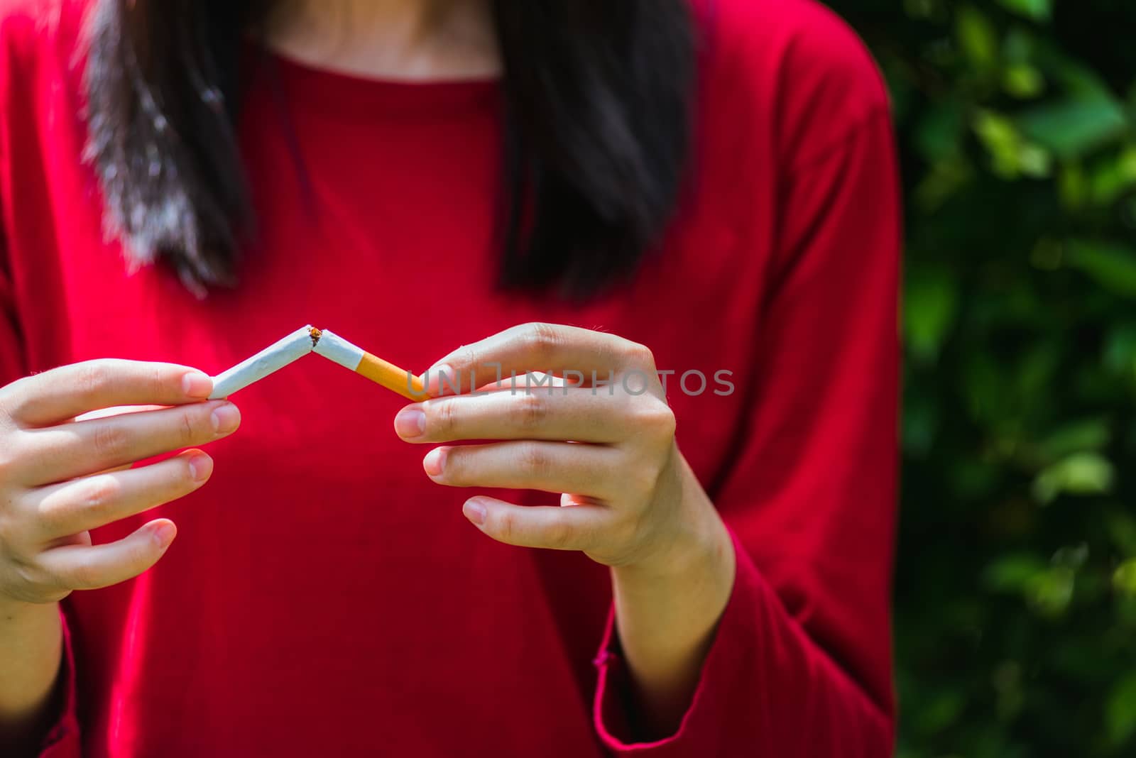 May 31 of World No Tobacco Day, Asian smoker woman use hands breaking down cigarettes, Stop or quit smoking concept