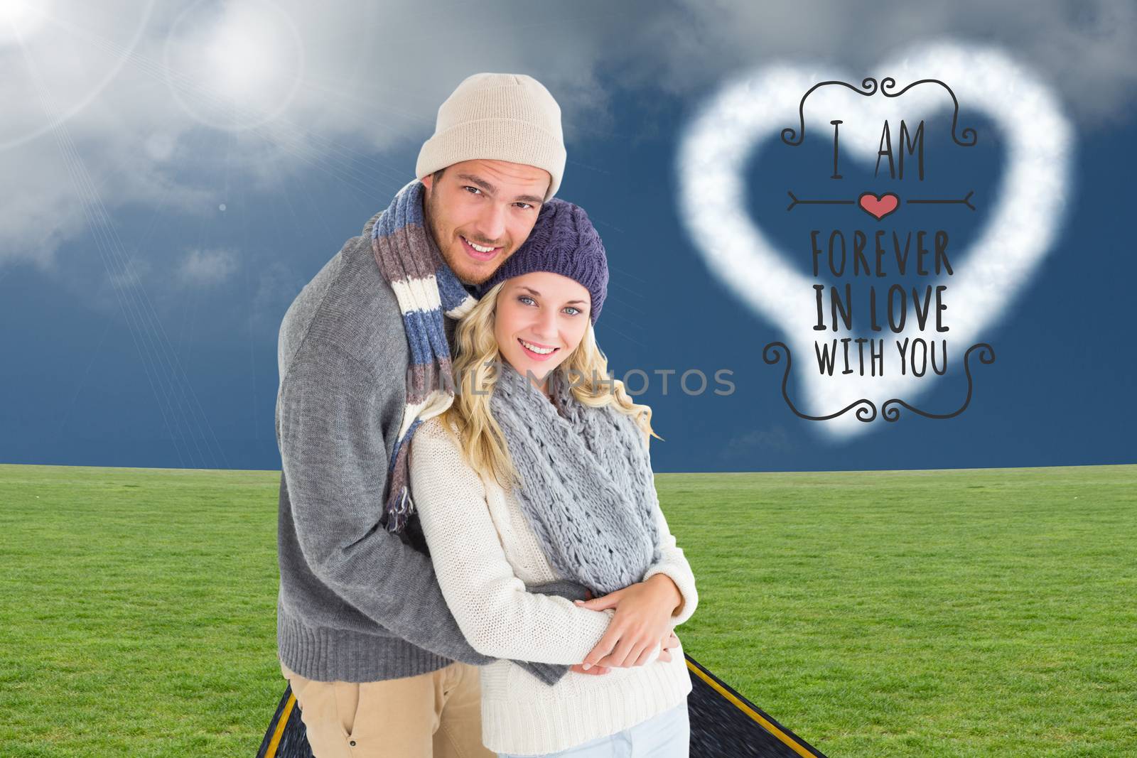 Composite image of attractive couple in winter fashion hugging by Wavebreakmedia