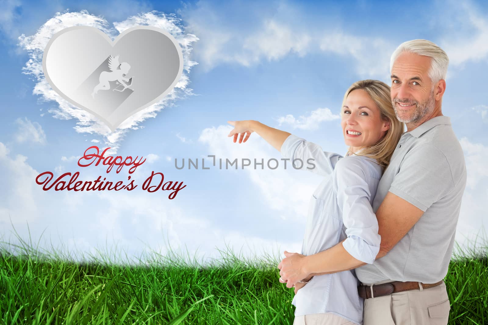 Composite image of happy couple smiling at camera and pointing by Wavebreakmedia