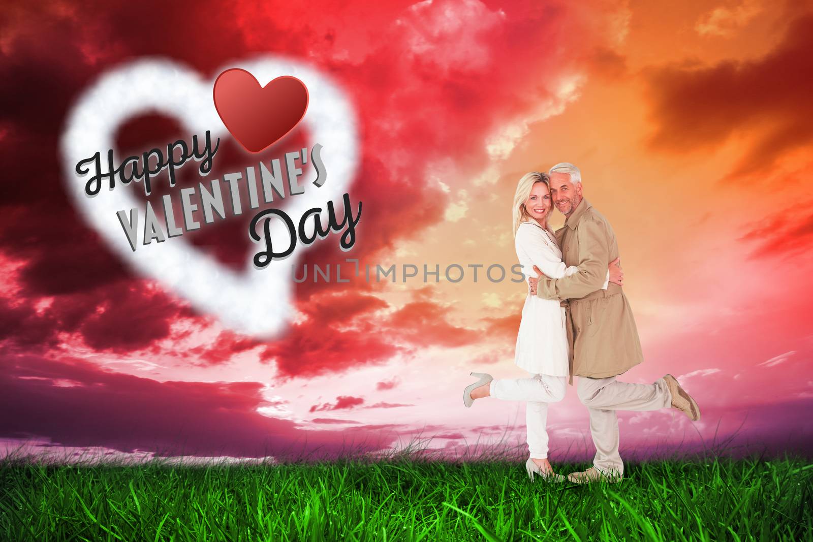 Happy couple posing in trench coats against green grass under red and purple sky