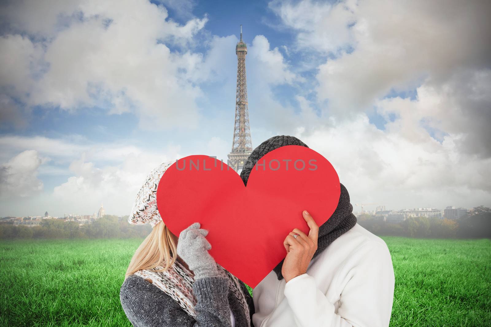 Composite image of couple in winter fashion posing with heart shape by Wavebreakmedia