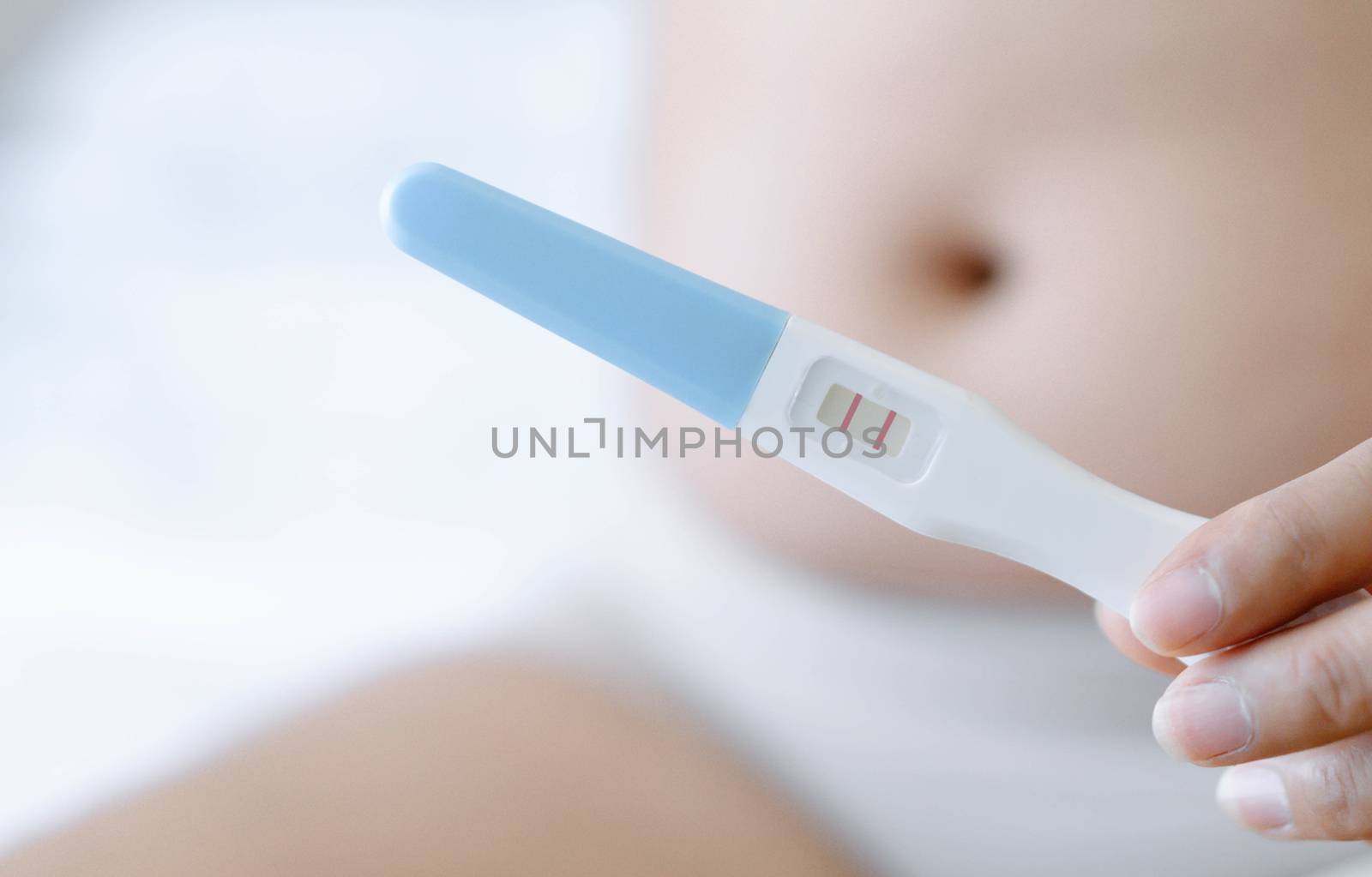 Closeup woman hand holding pregnancy test with happy moment, health care concept, selective focus