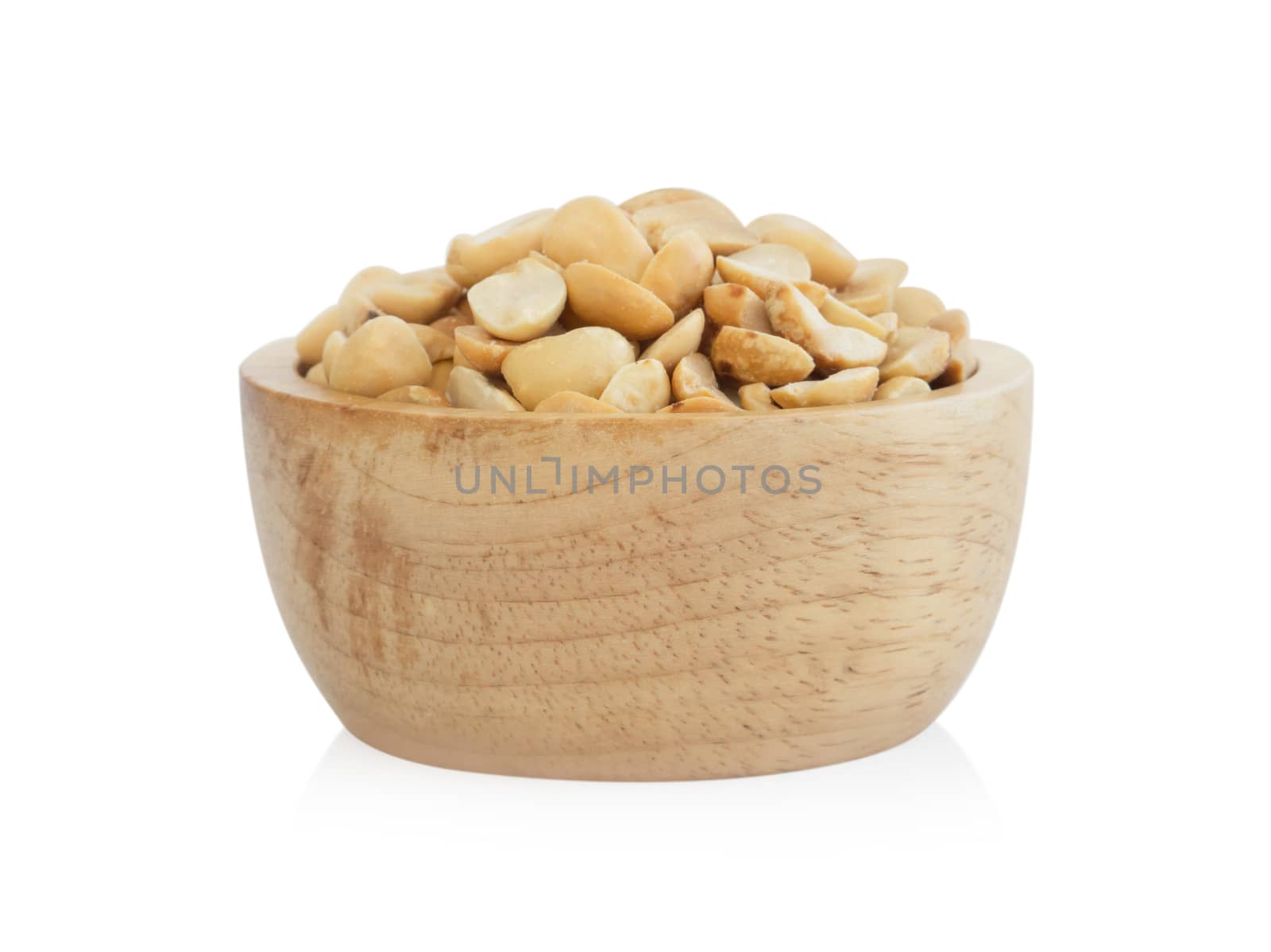 Roasted peanuts in wooden bowl on white background, healthy food concept