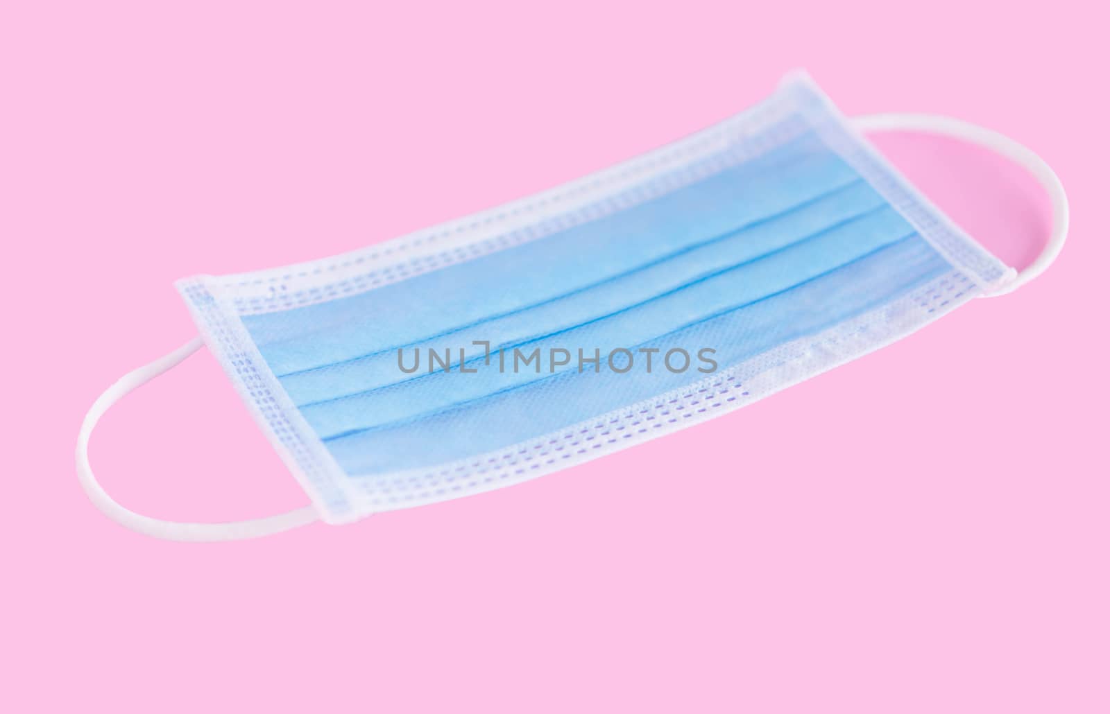 Medical mask isolated on pink background for protect air polution or virus covid 19, health care concept