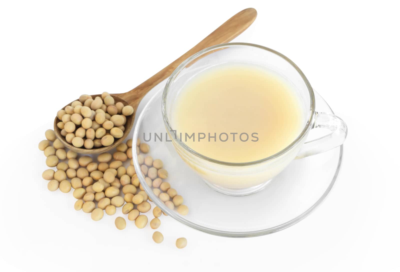 Soymilk in glass with soy beans in wooden spoon isolated on white backgroun, health care concept