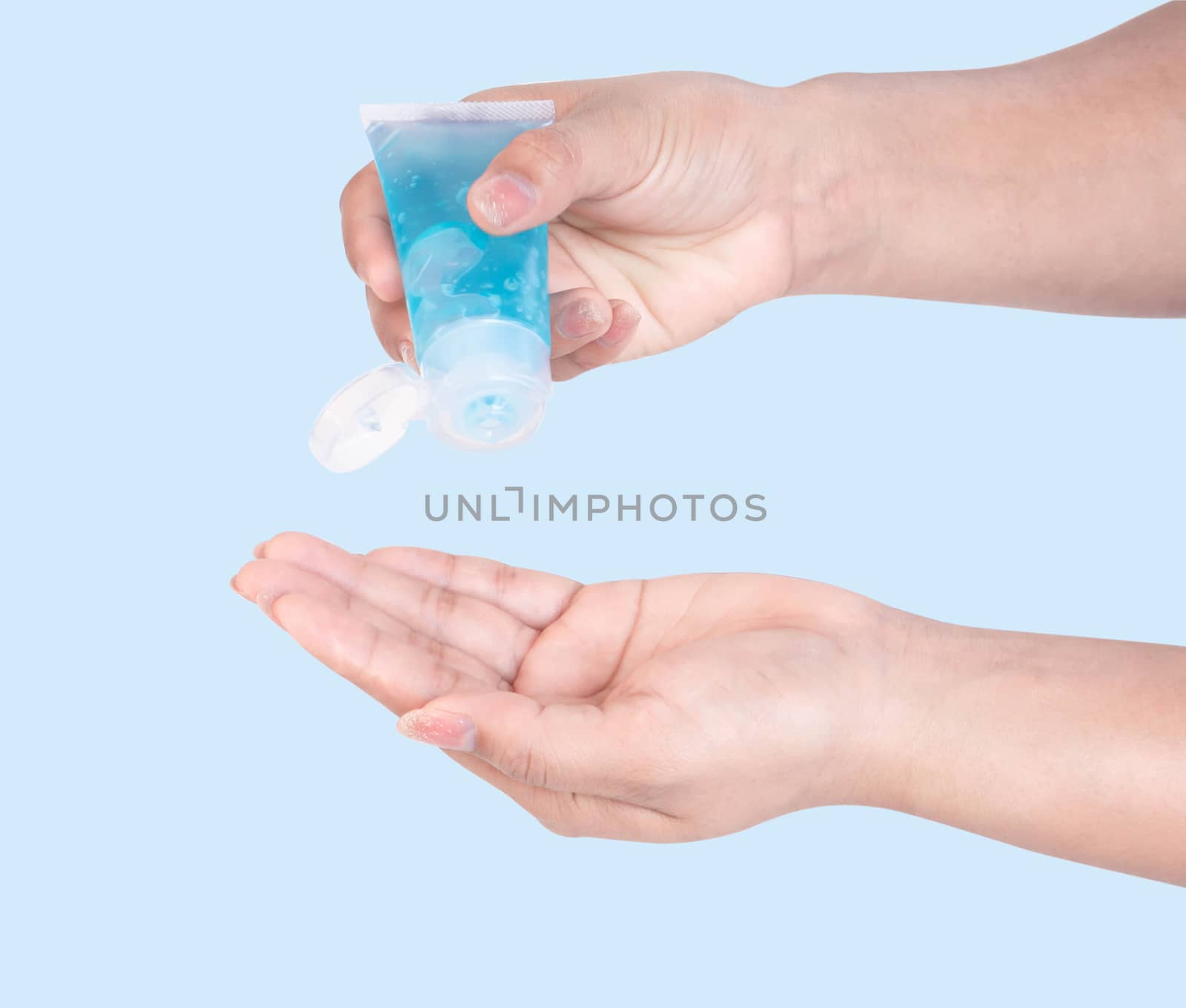 Woman hand using alcohol gel in plastic tube for washing hand, health care and medical concept
