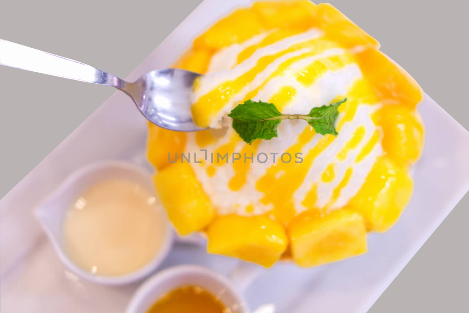 Close up mango bing su with sauces in white plate