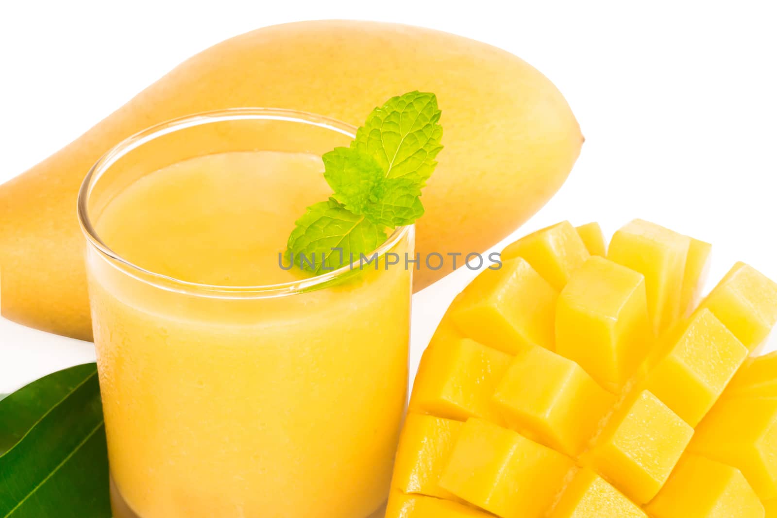 Closeup glass of mango fruit juice isolated on white background