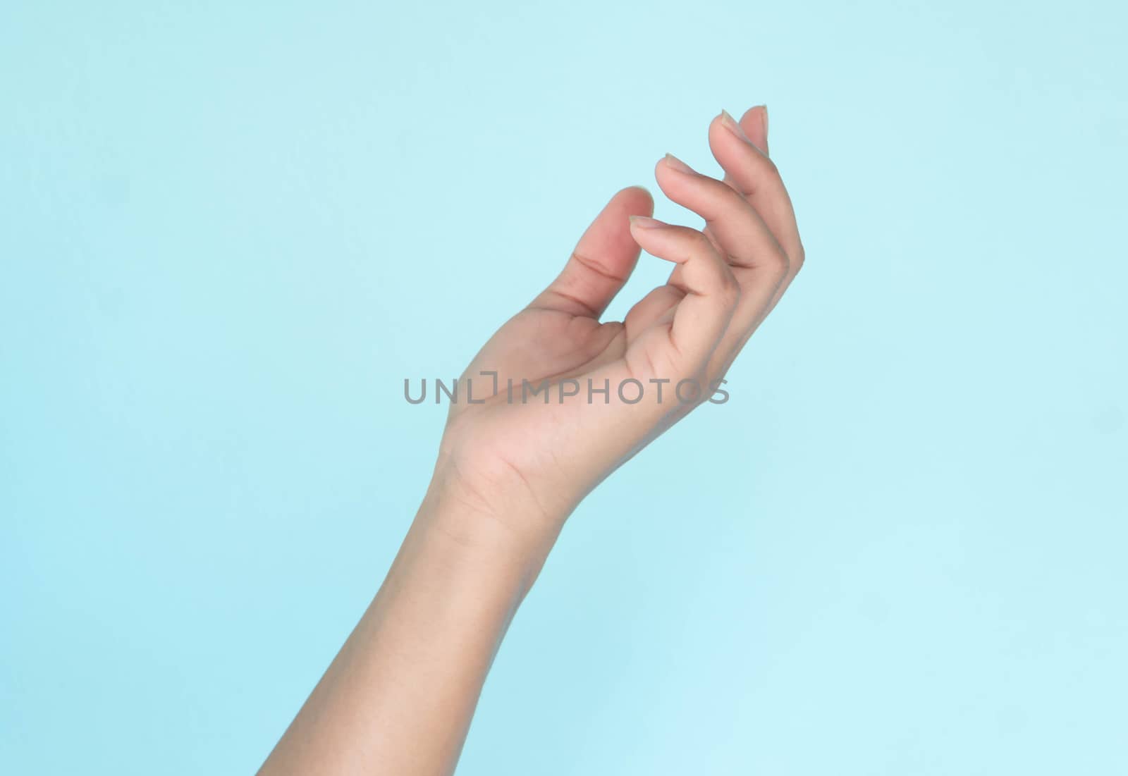 Woman hands holding something on blue background for product advertising concept