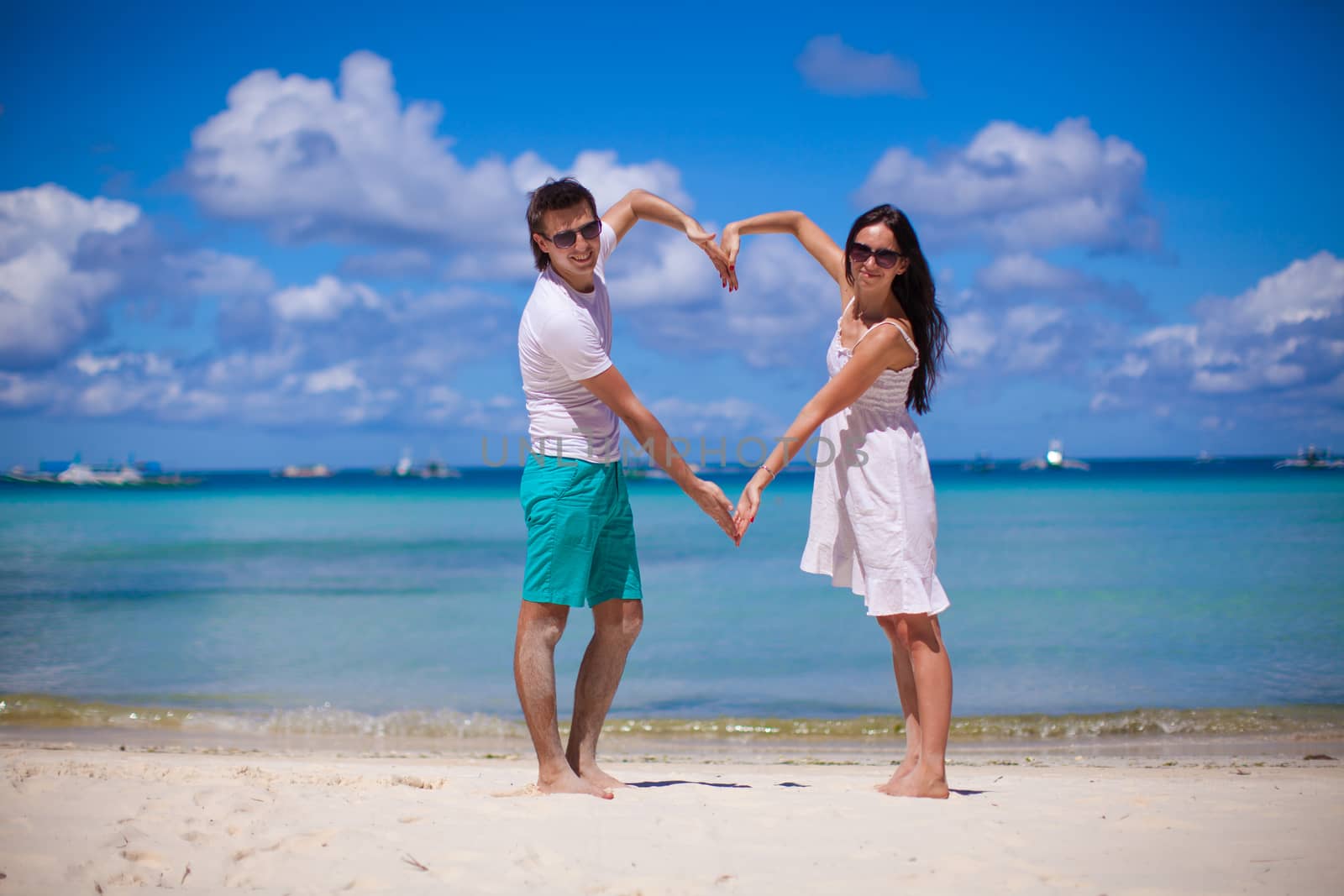 Romantic couple enjoy vacation on tropical white beach by travnikovstudio