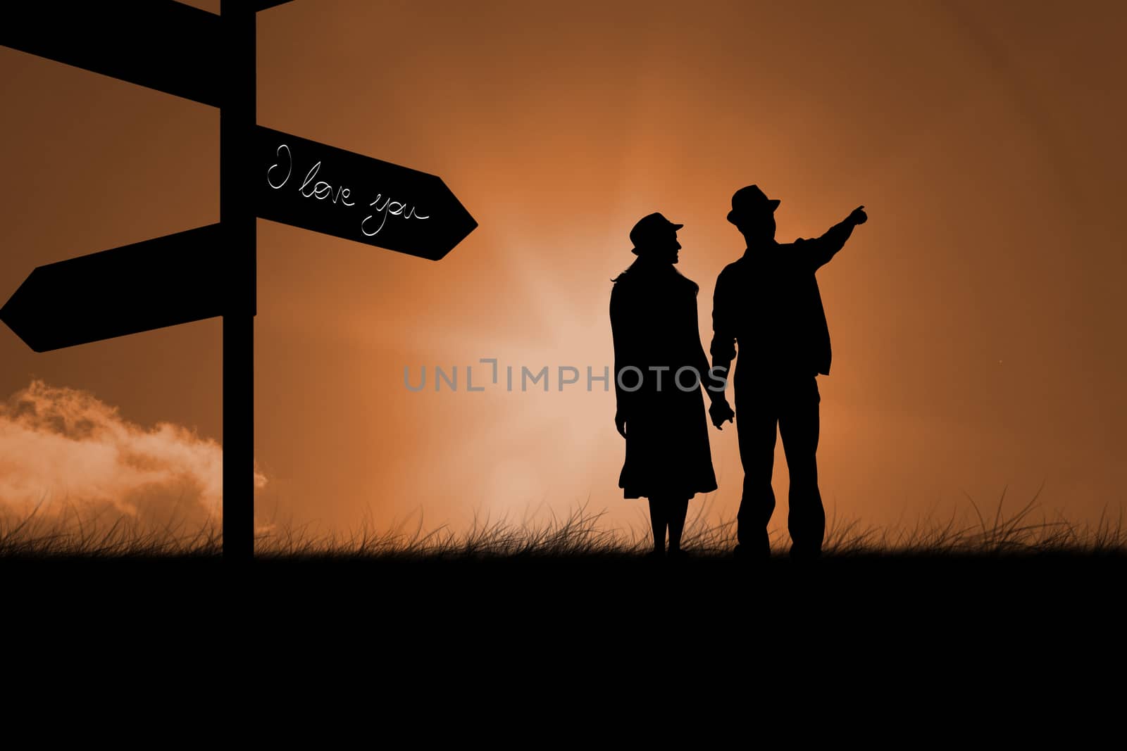 Happy hipster couple holding hands and looking against sunrise