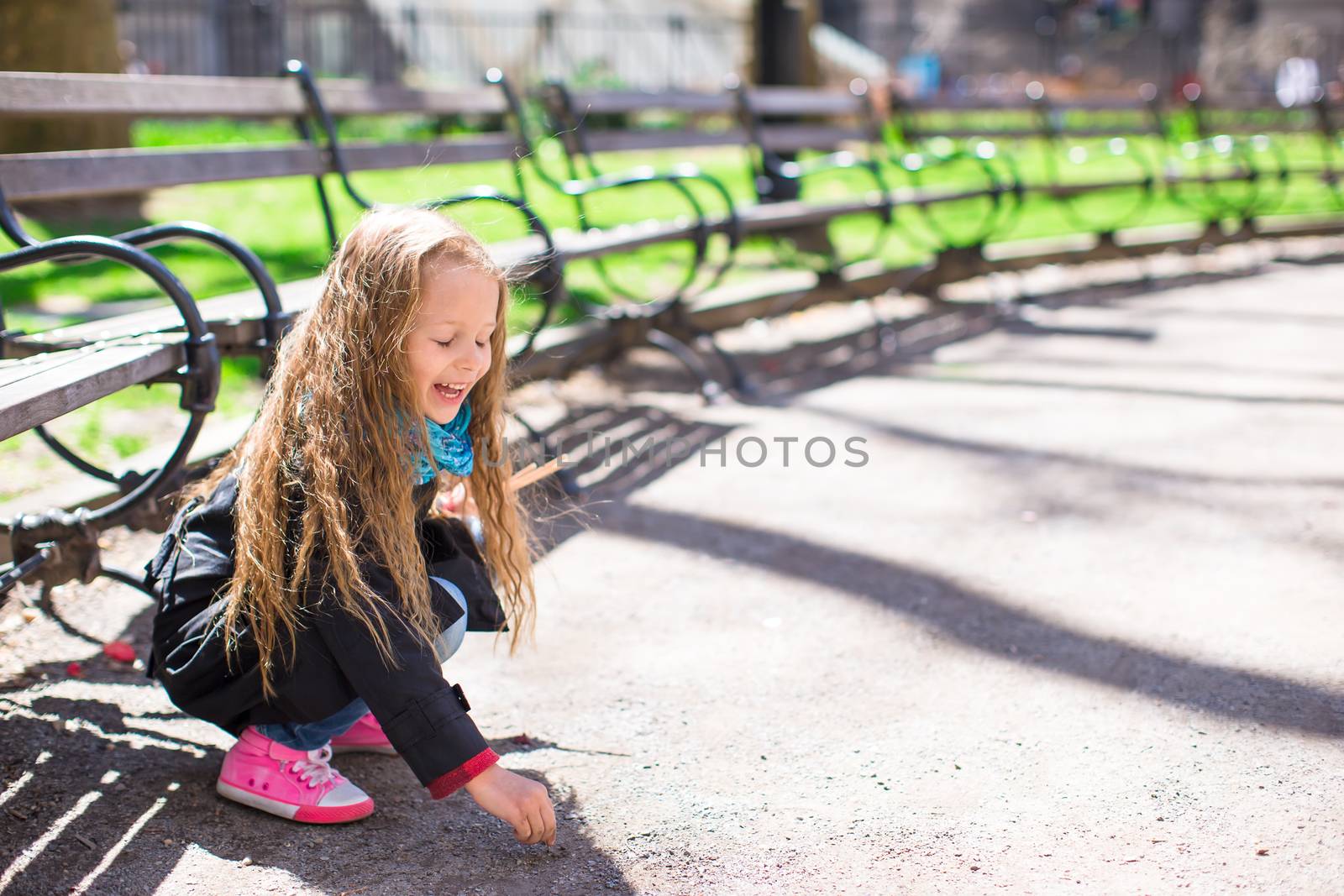 Adorable little girl have fun in Central Park at New York City by travnikovstudio