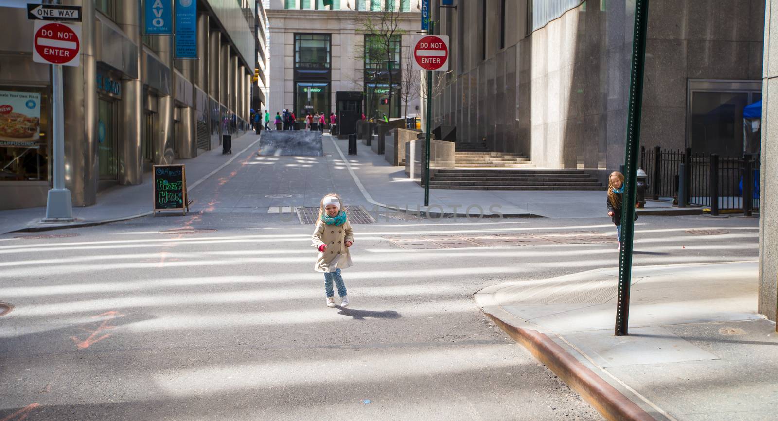 Adorable little girl walking in New York City at spring sunny day by travnikovstudio