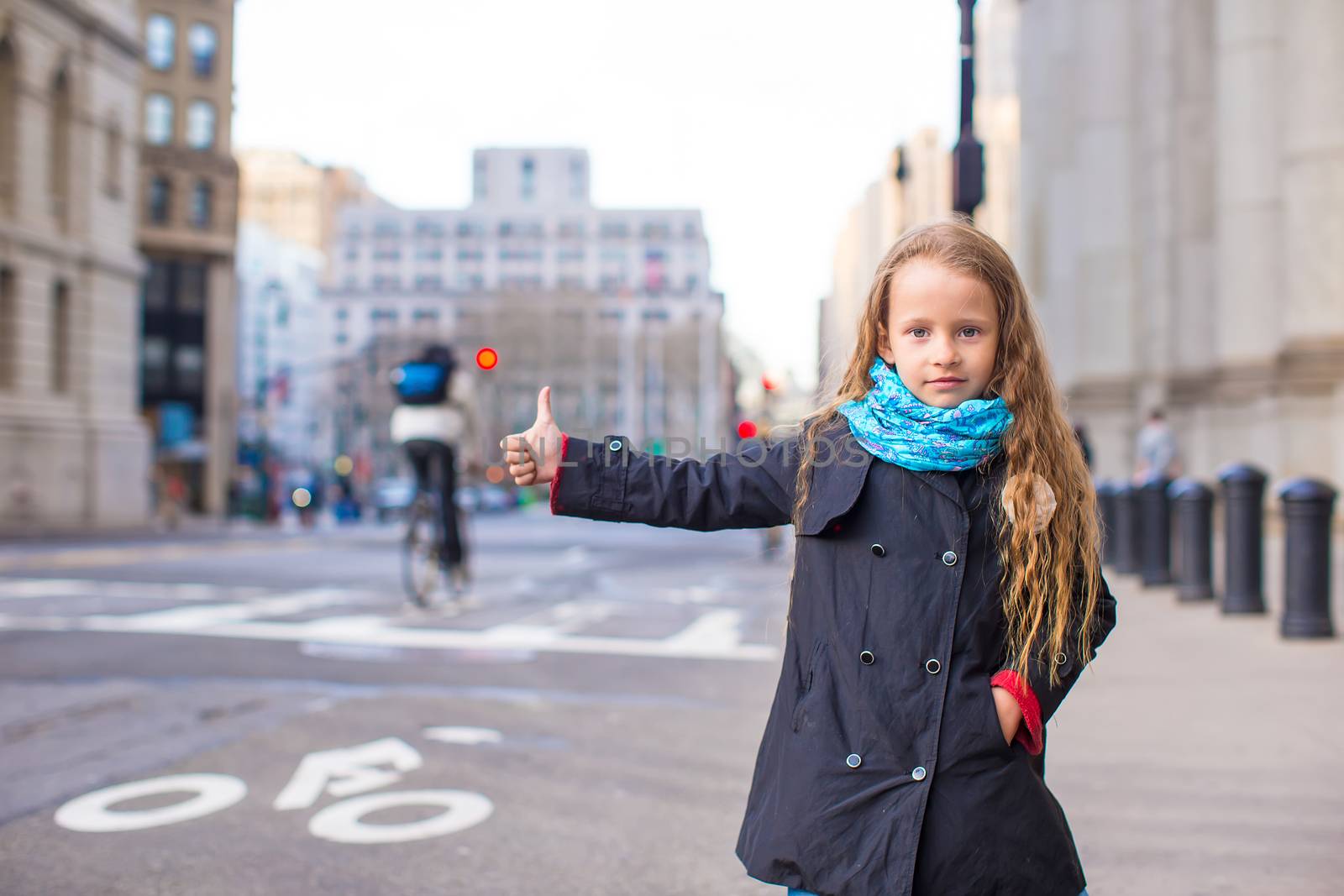 Adorable little girl get taxi at New York City by travnikovstudio