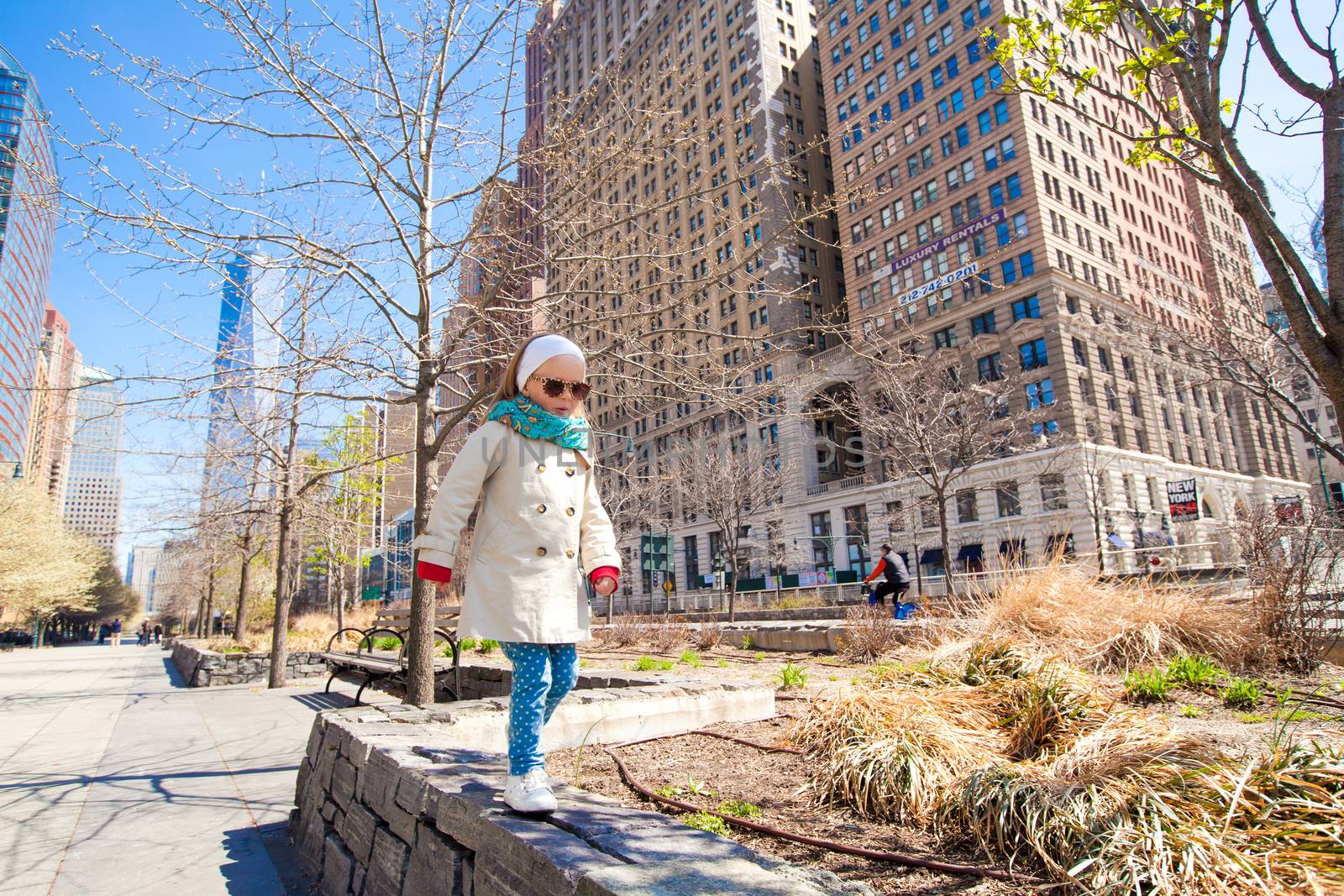 Adorable little girl walking in New York City at spring sunny day by travnikovstudio