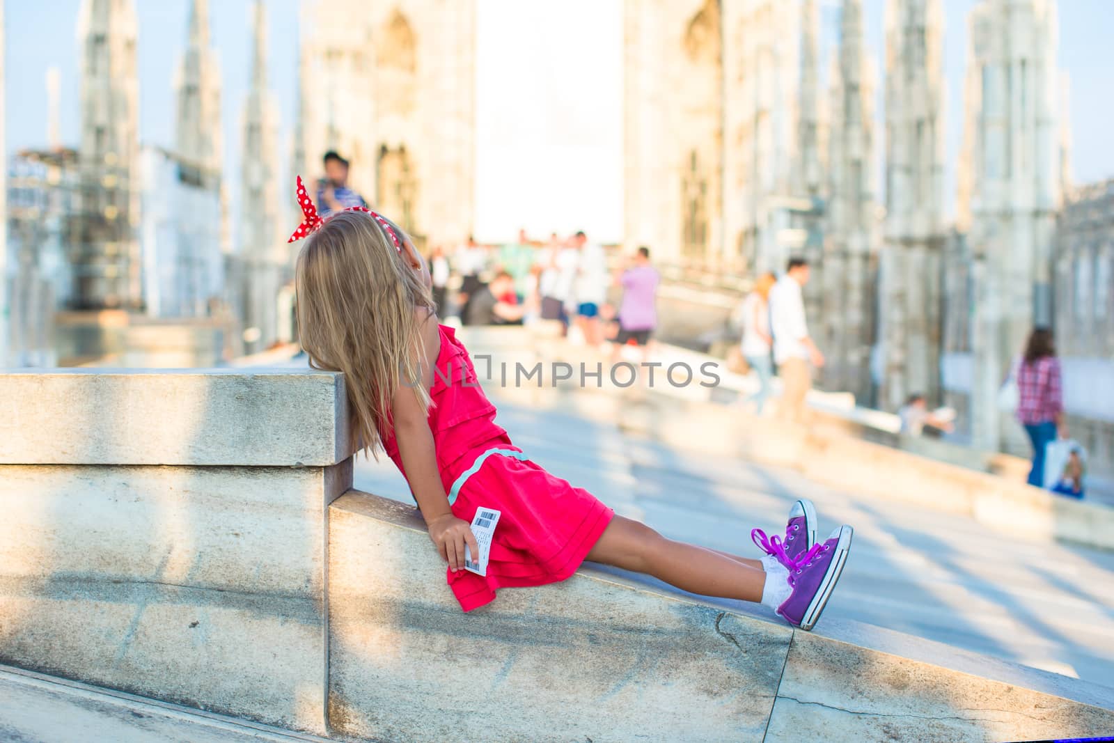 Adorable little girl on the rooftop of Duomo, Milan, Italy by travnikovstudio