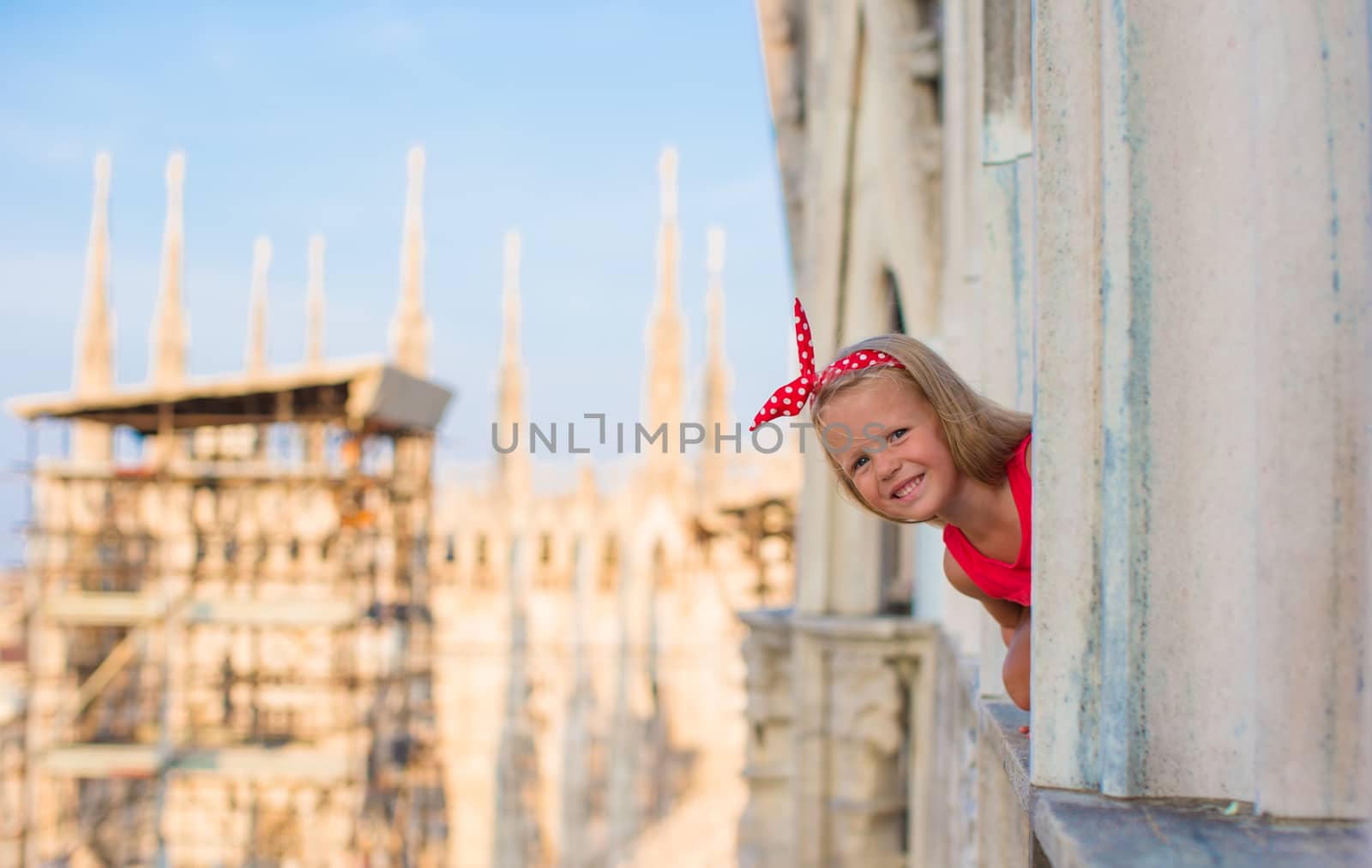 Adorable little girl on the rooftop of Duomo, Milan, Italy by travnikovstudio