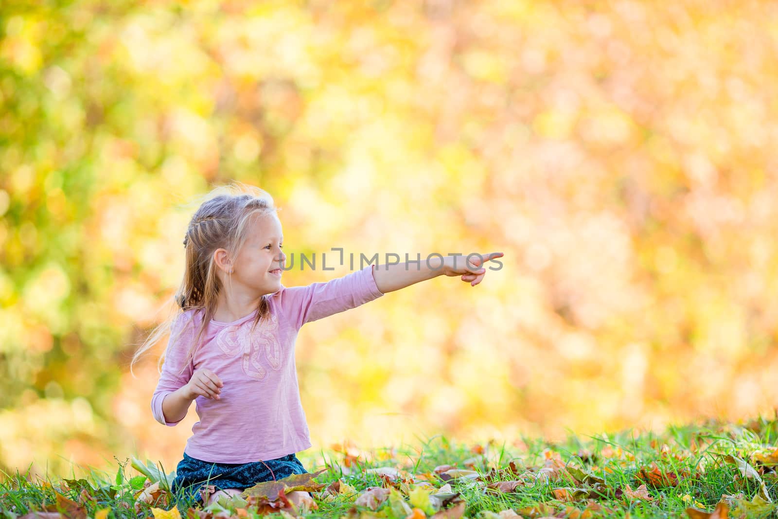 Adorable little girl at beautiful autumn day outdoors by travnikovstudio