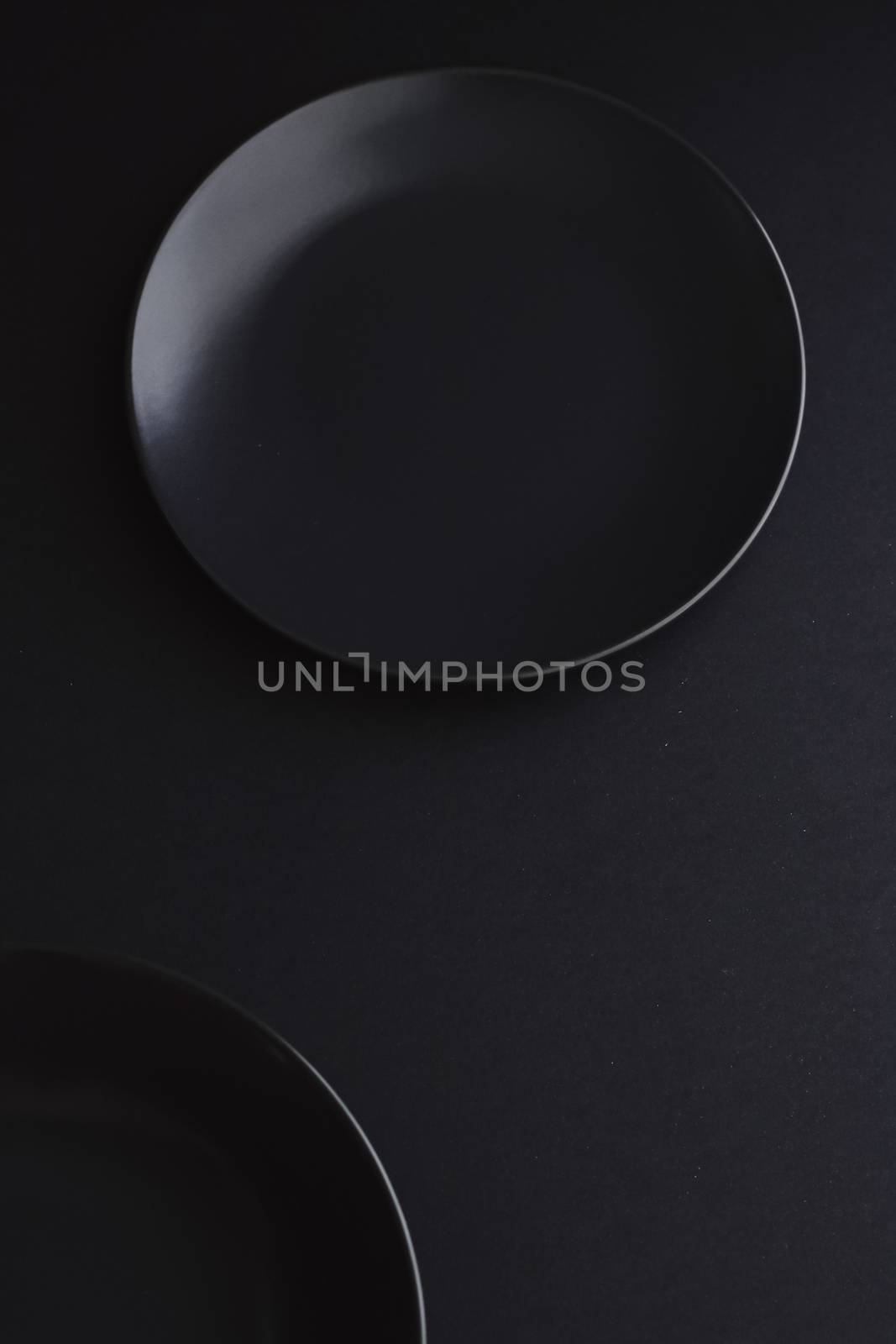 Empty plates on black background, premium dishware for holiday dinner, minimalistic design and diet concept