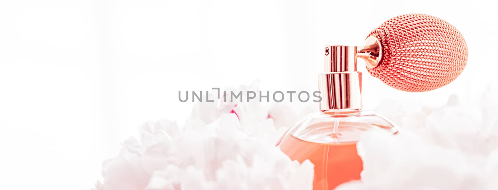 Vintage fragrance bottle as luxe perfume product on background of peony flowers, parfum ad and beauty branding design