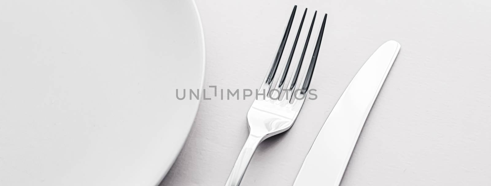 Empty plate and cutlery as mockup set on white background, top tableware for chef table decor and menu branding design