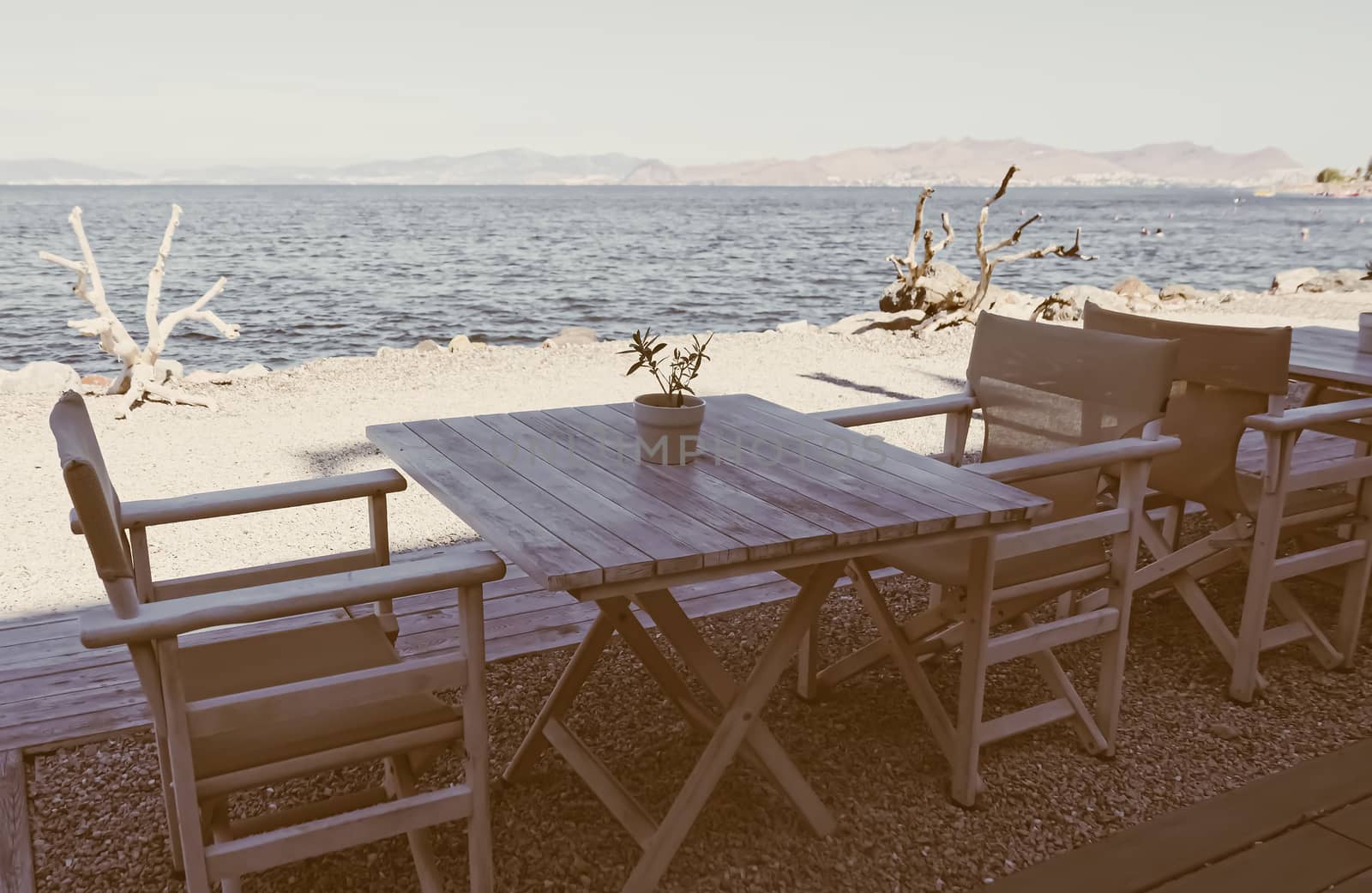 Empty restaurant by the Aegean sea and cruise boat, travel and nature by Anneleven