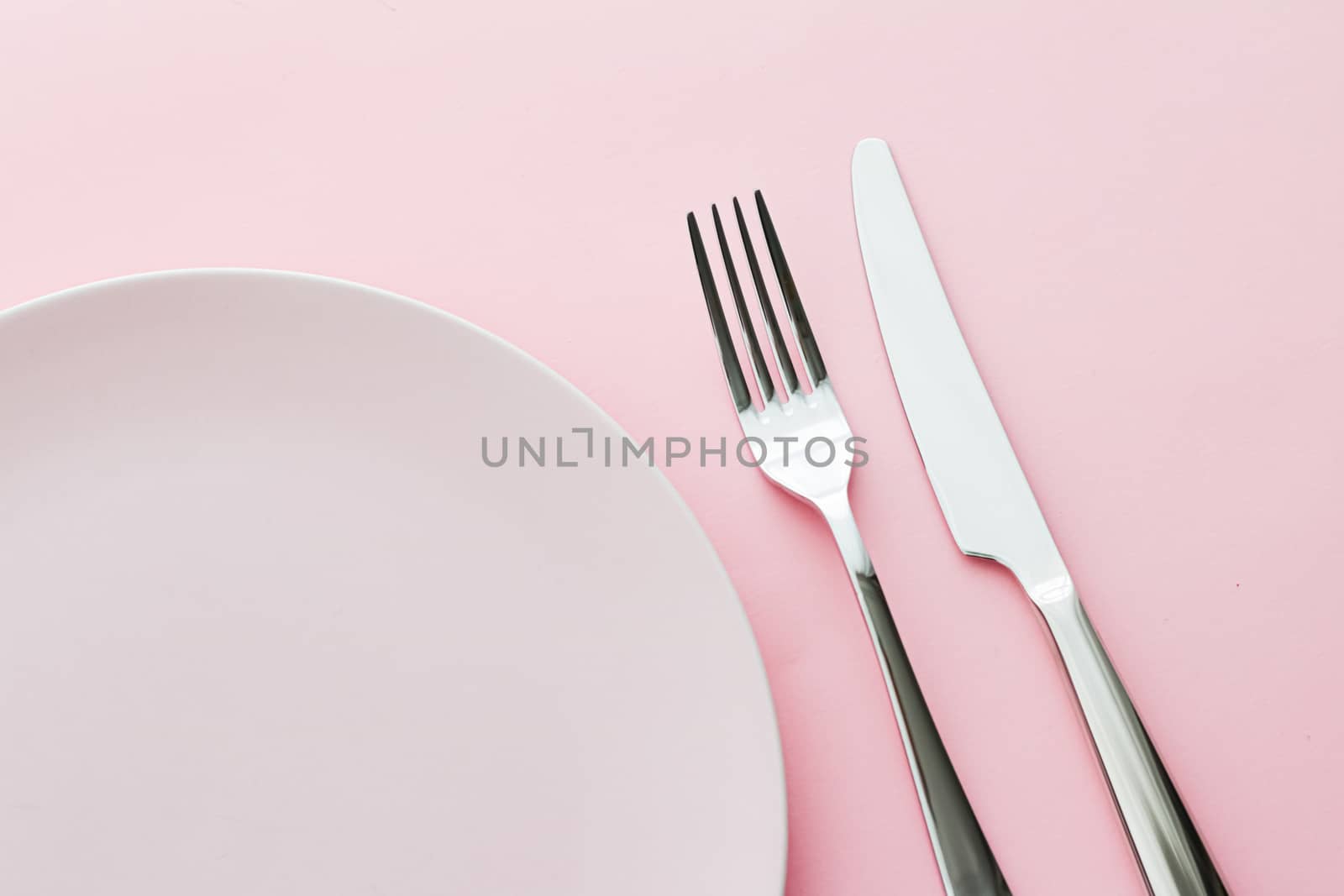 Empty plate and cutlery as mockup set on pink background, top tableware for chef table decor and menu branding design