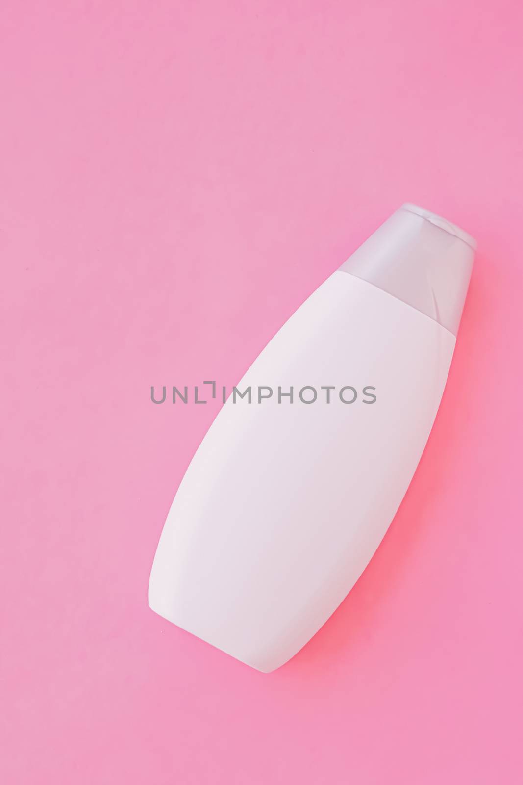 Blank label shampoo bottle or shower gel on pink background, beauty product and body care cosmetics, flatlay