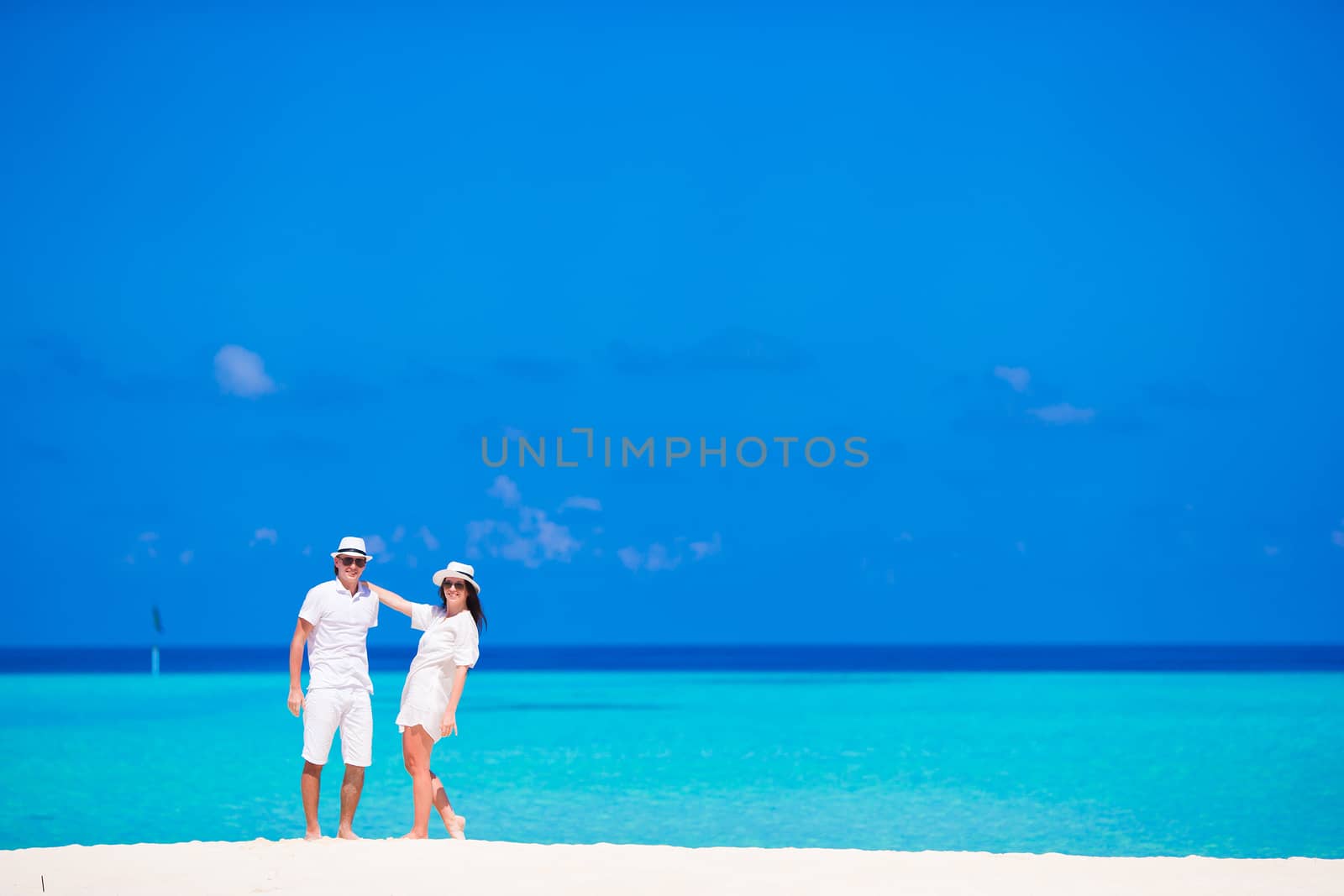 Young family during beach romantic vacation by travnikovstudio