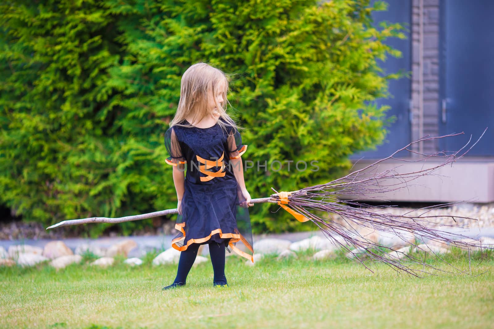 Adorable little girl wearing witch costume on Halloween at autumn day. Trick or treat. by travnikovstudio