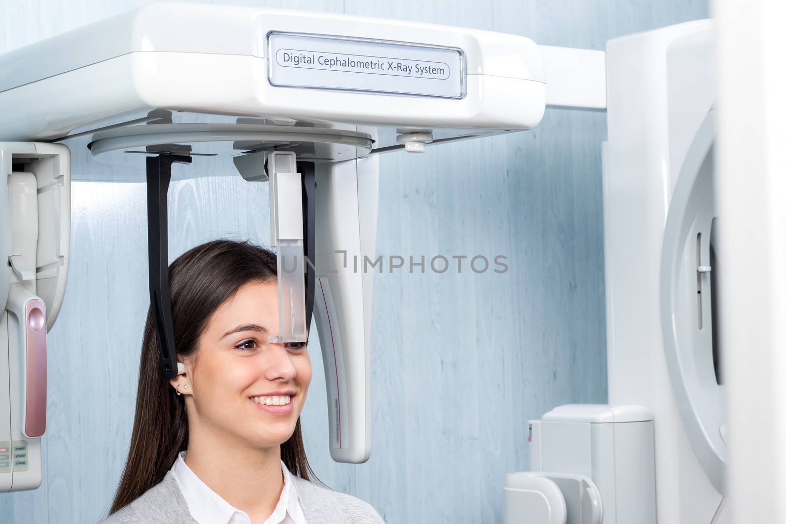 Close up of girl in 3d digital cephalometric panorama x-ray machine in clinic. Woman having dental tac taken.