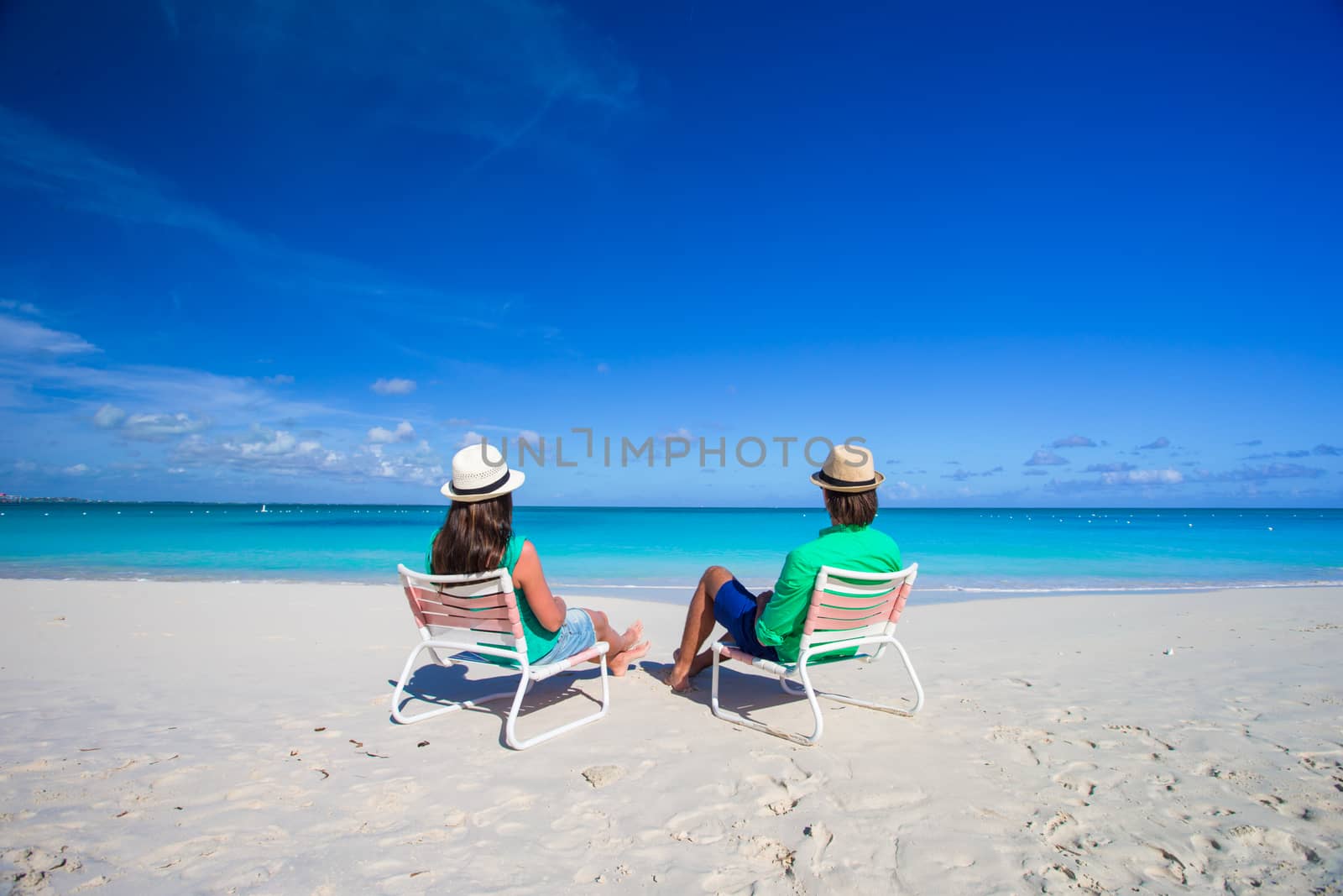 Young happy couple on white beach during vacation by travnikovstudio