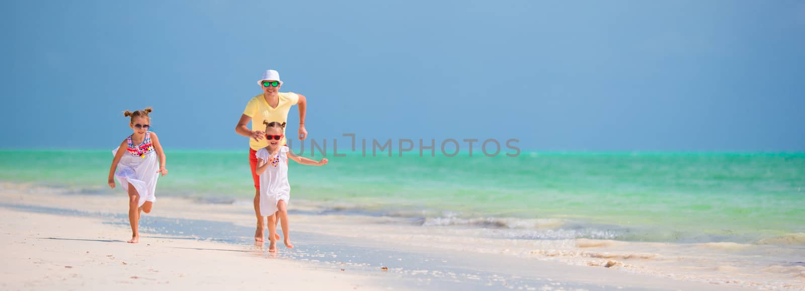 Happy family on beach vacation by travnikovstudio
