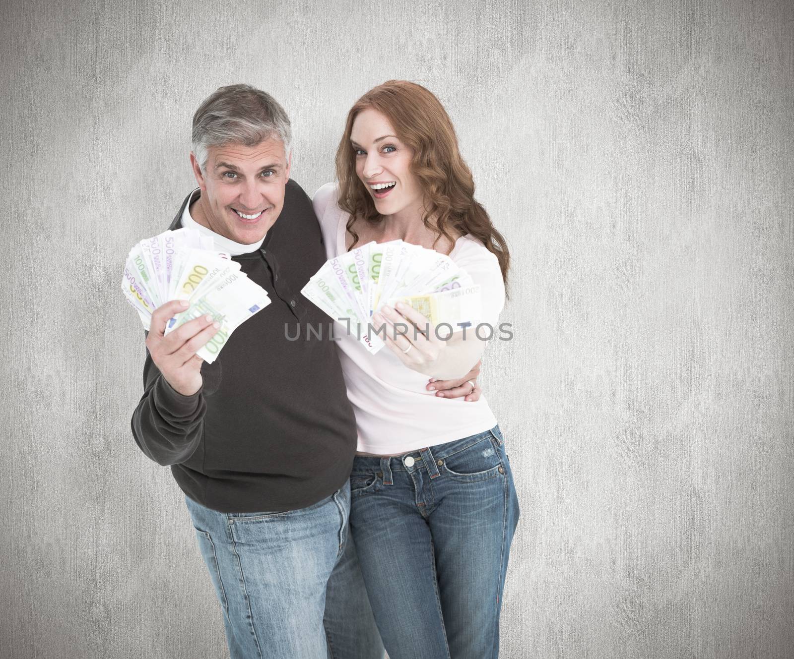 Casual couple showing their cash against white background