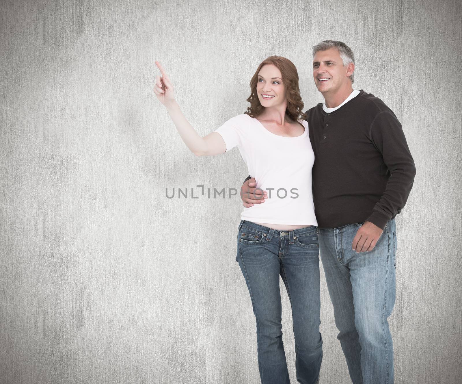 Composite image of casual couple walking and pointing by Wavebreakmedia