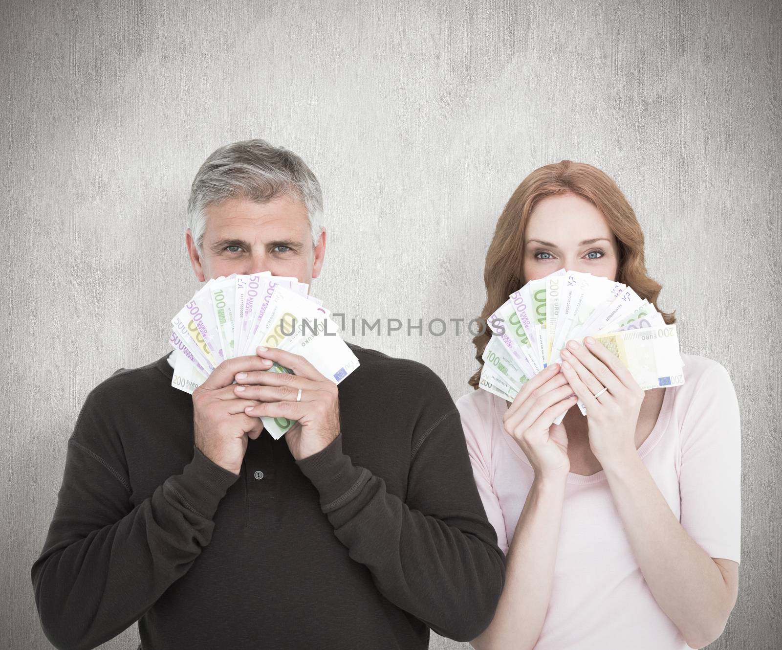 Casual couple showing their cash against white background