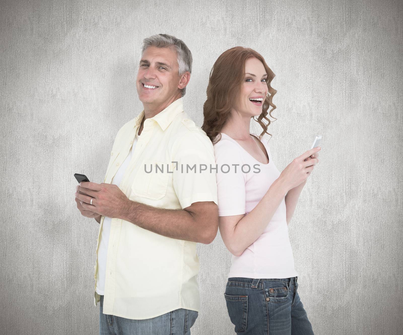 Composite image of casual couple sending text messages by Wavebreakmedia