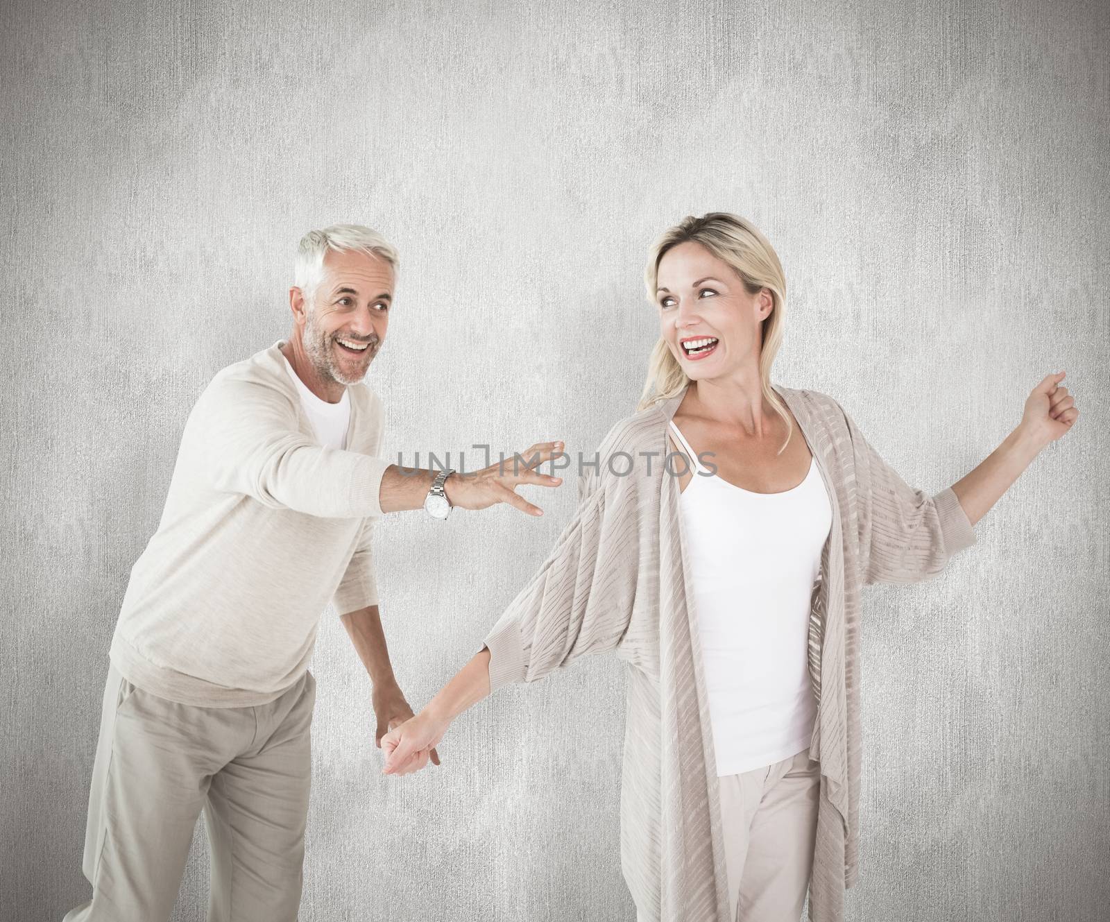 Happy couple messing about together against white background