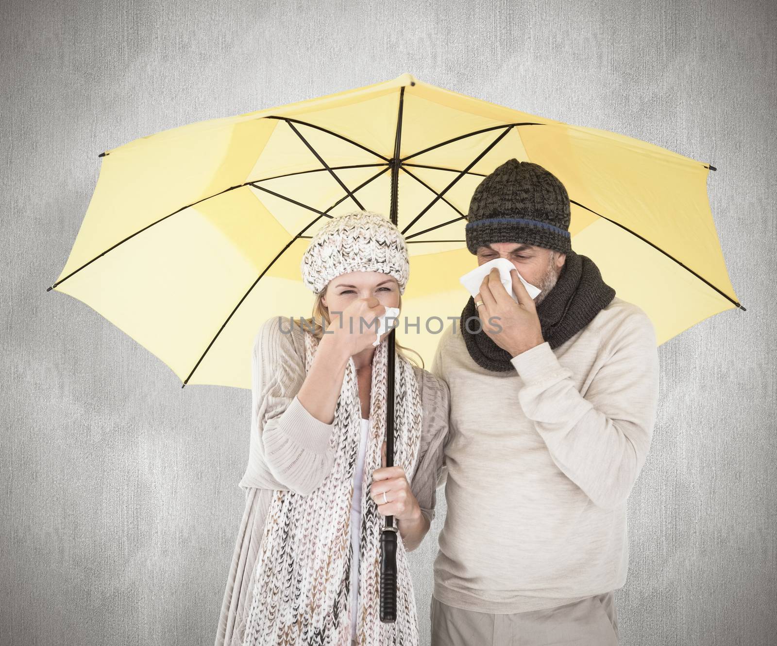 Composite image of couple in winter fashion sneezing under umbrella by Wavebreakmedia