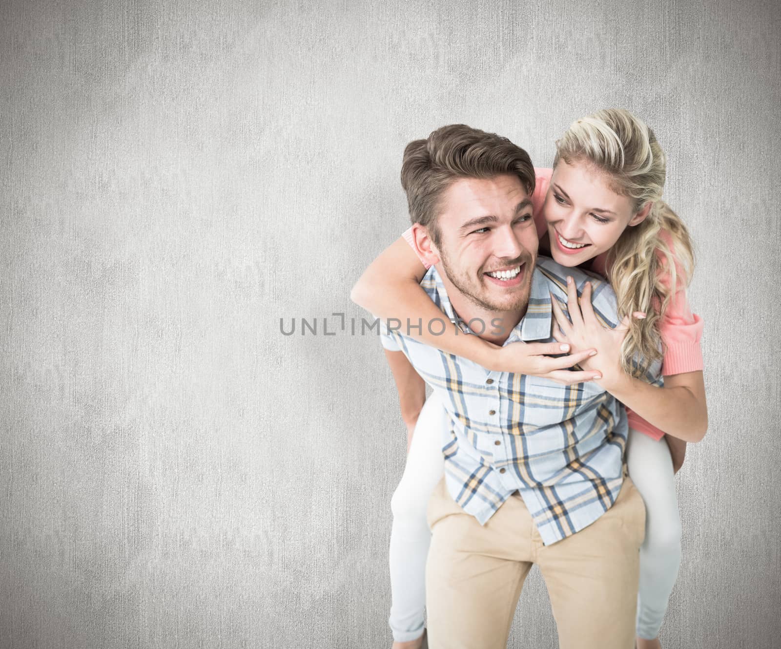 Handsome man giving piggy back to his girlfriend against white background