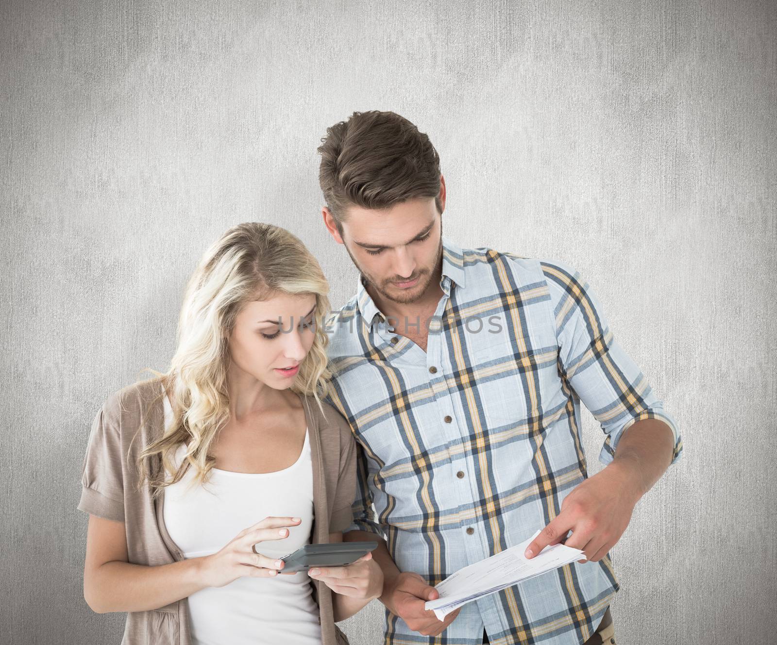 Attractive couple working out their finances against white background