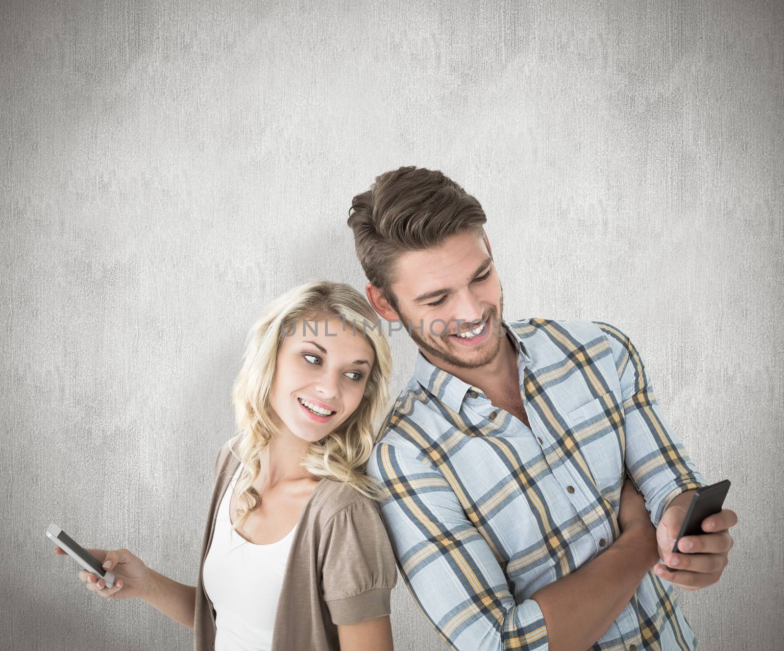 Attractive couple using their smartphones against white background