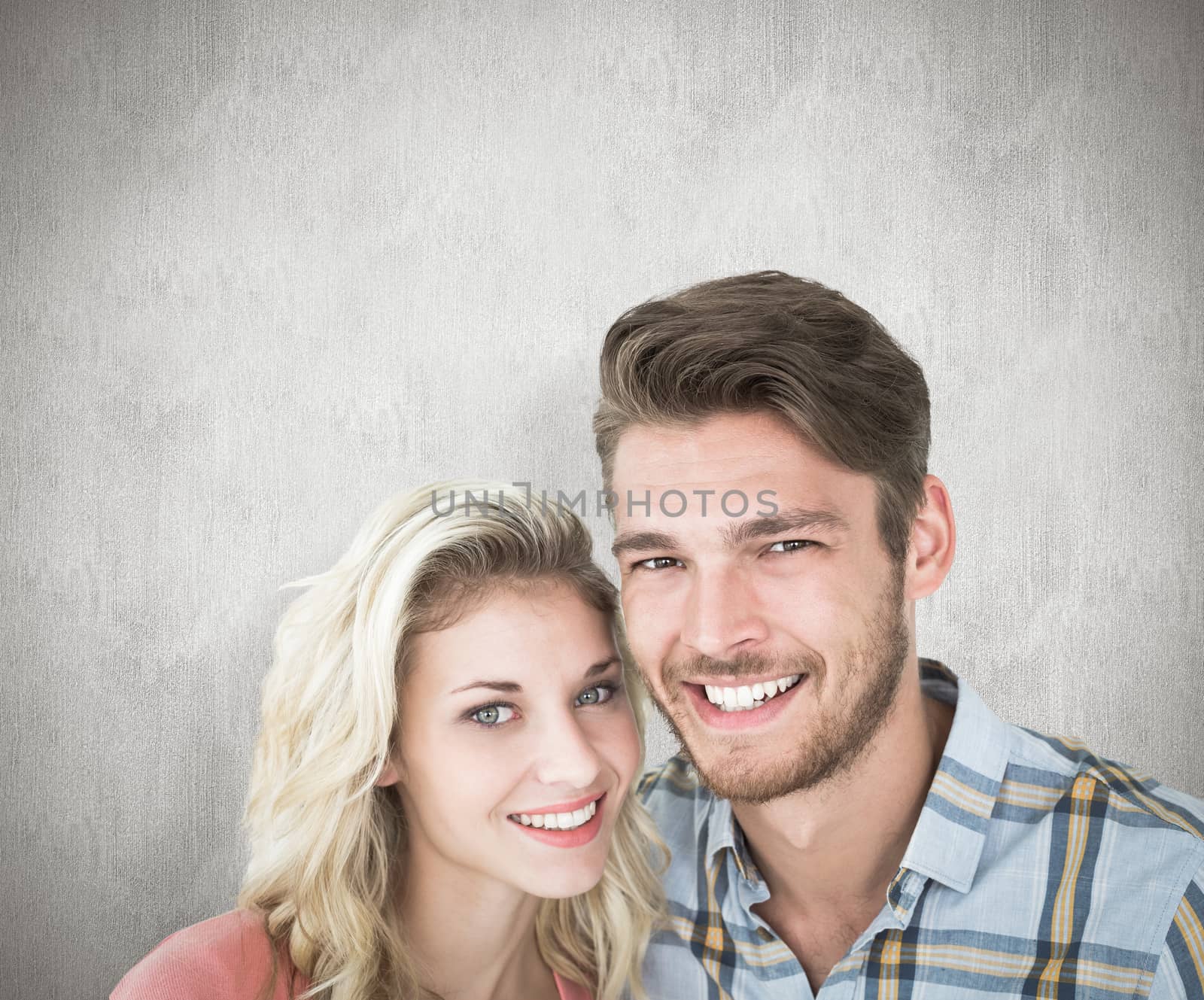 Attractive young couple smiling at camera against white background