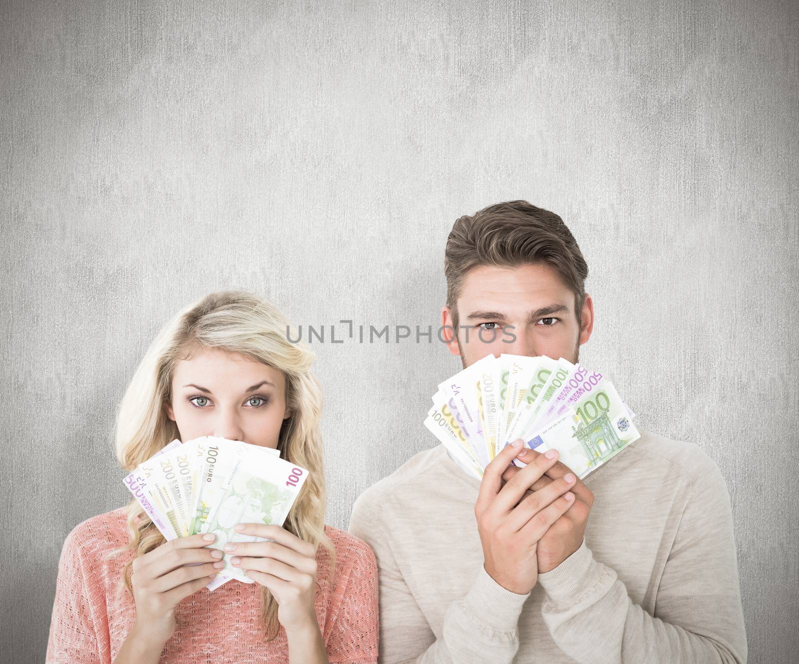 Attractive couple flashing their cash against white background