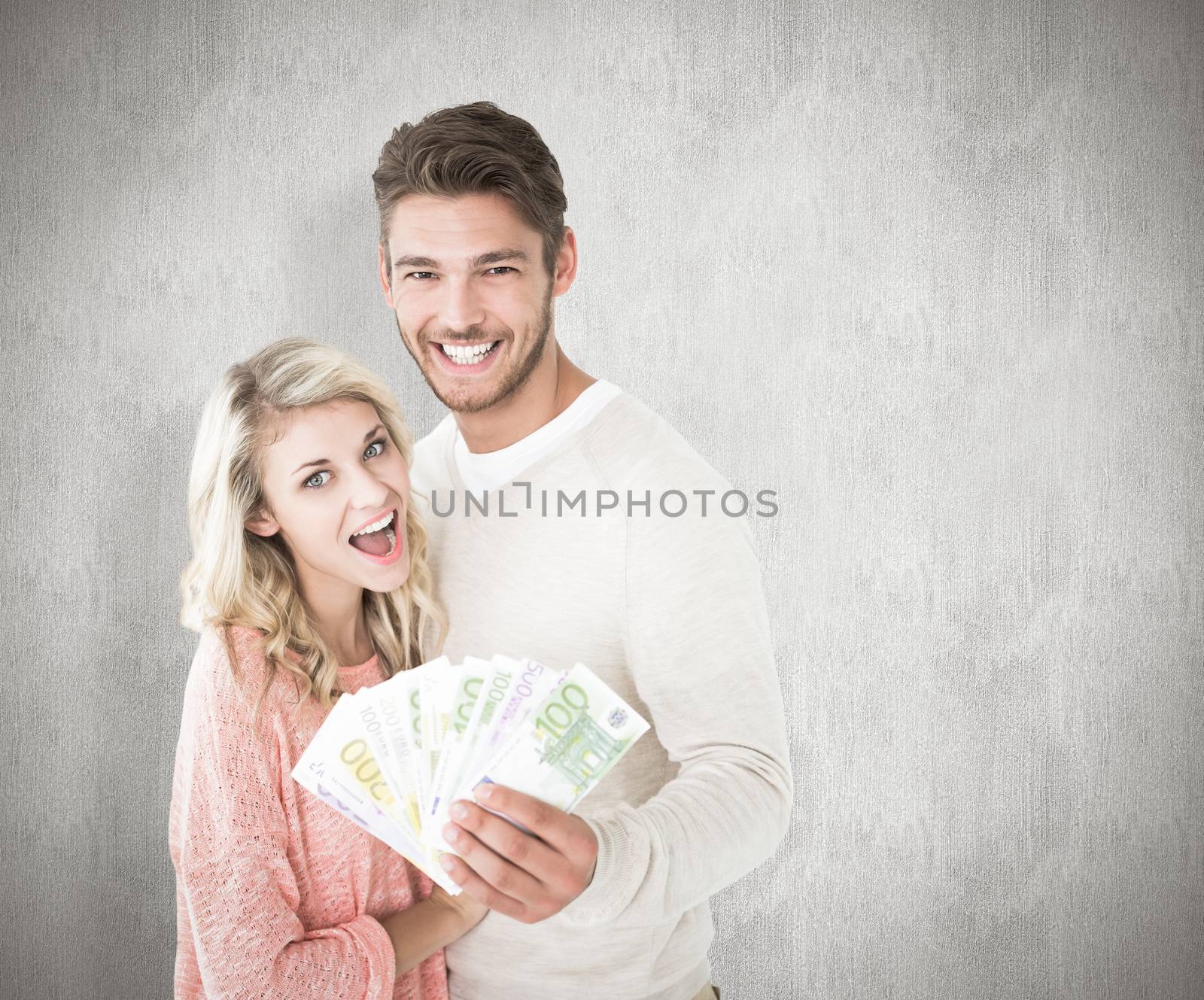 Attractive couple flashing their cash against white background