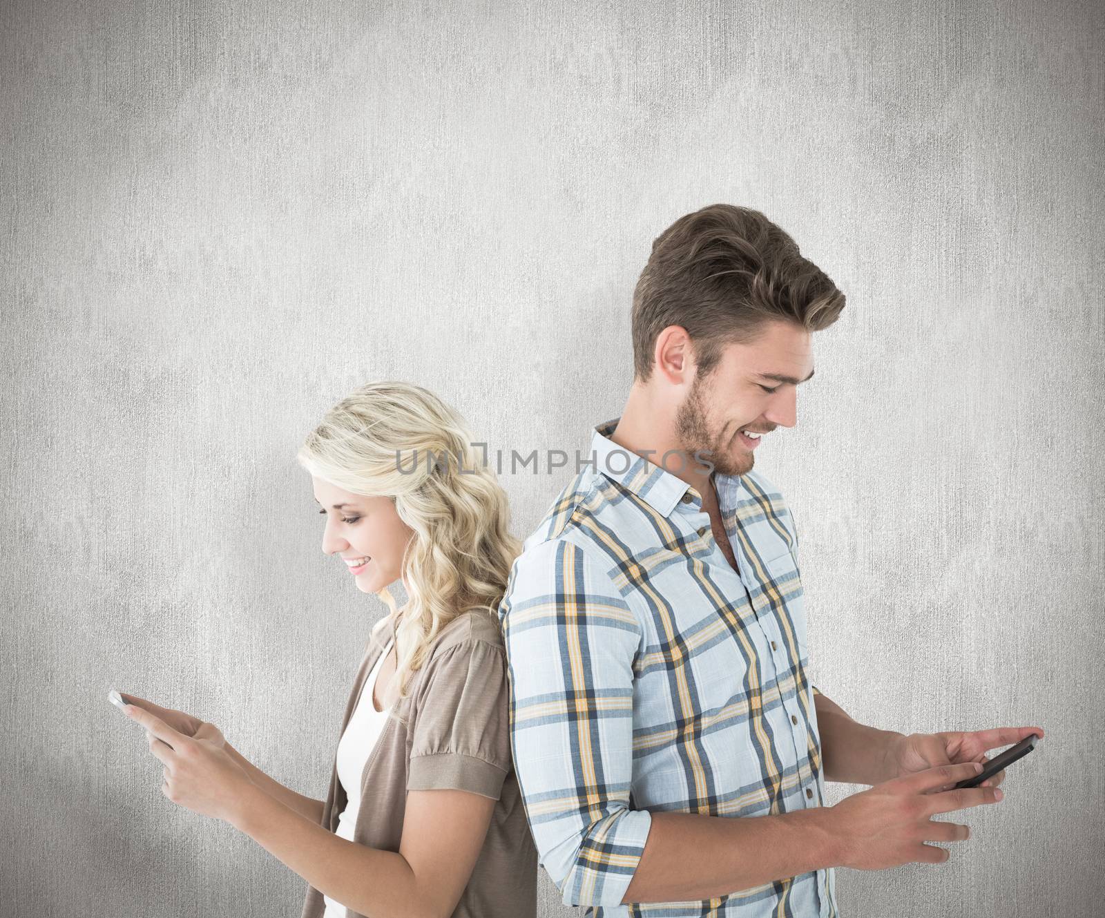 Attractive couple using their smartphones against white background