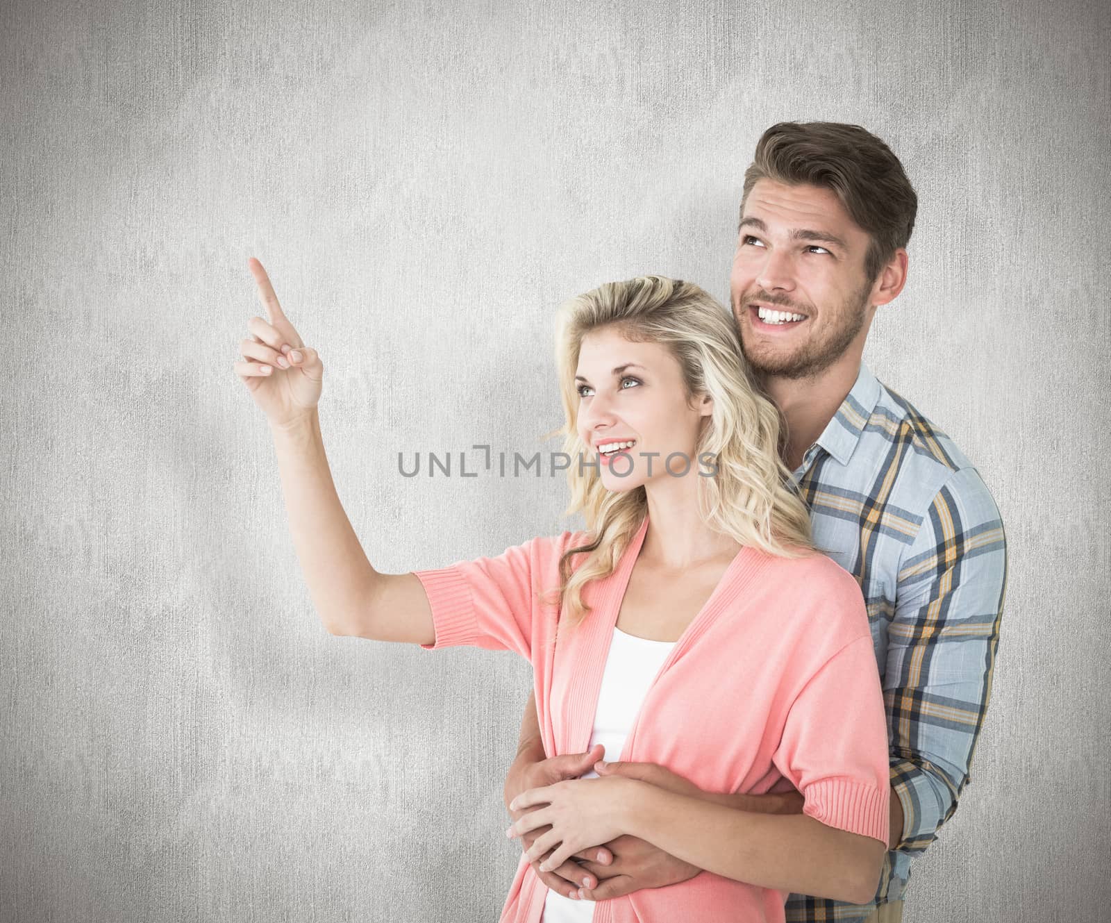 Attractive young couple embracing and looking against white background