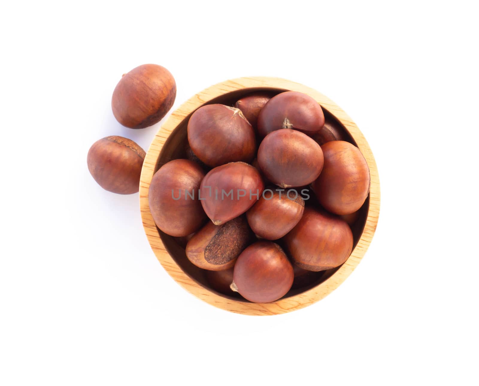 Closeup horse chestnuts in wood bowl isolated on white background,  healthy food concept